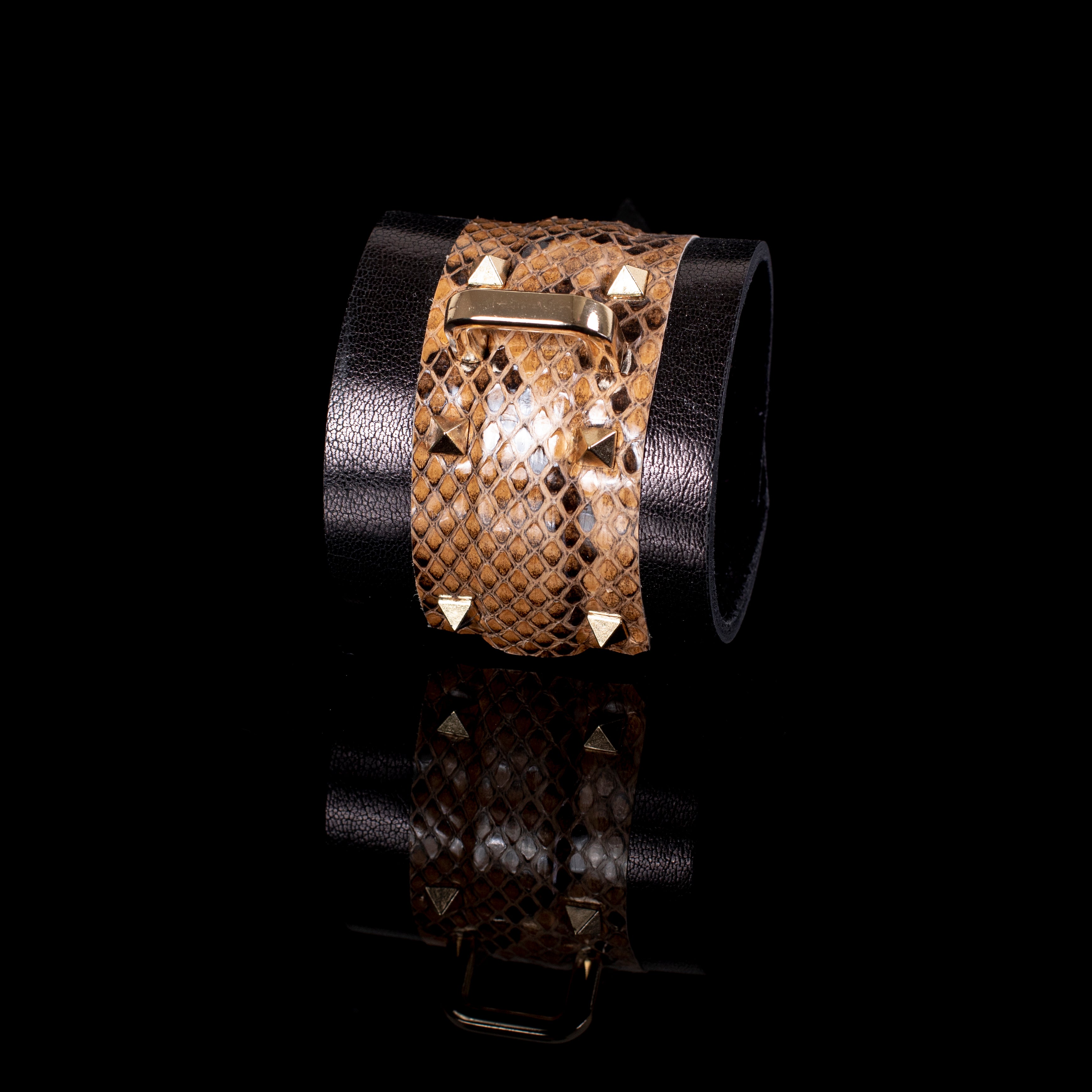 Brown python leather cuff bracelet with black wide band and gold metal bar detail, handcrafted statement wrist accessory for men