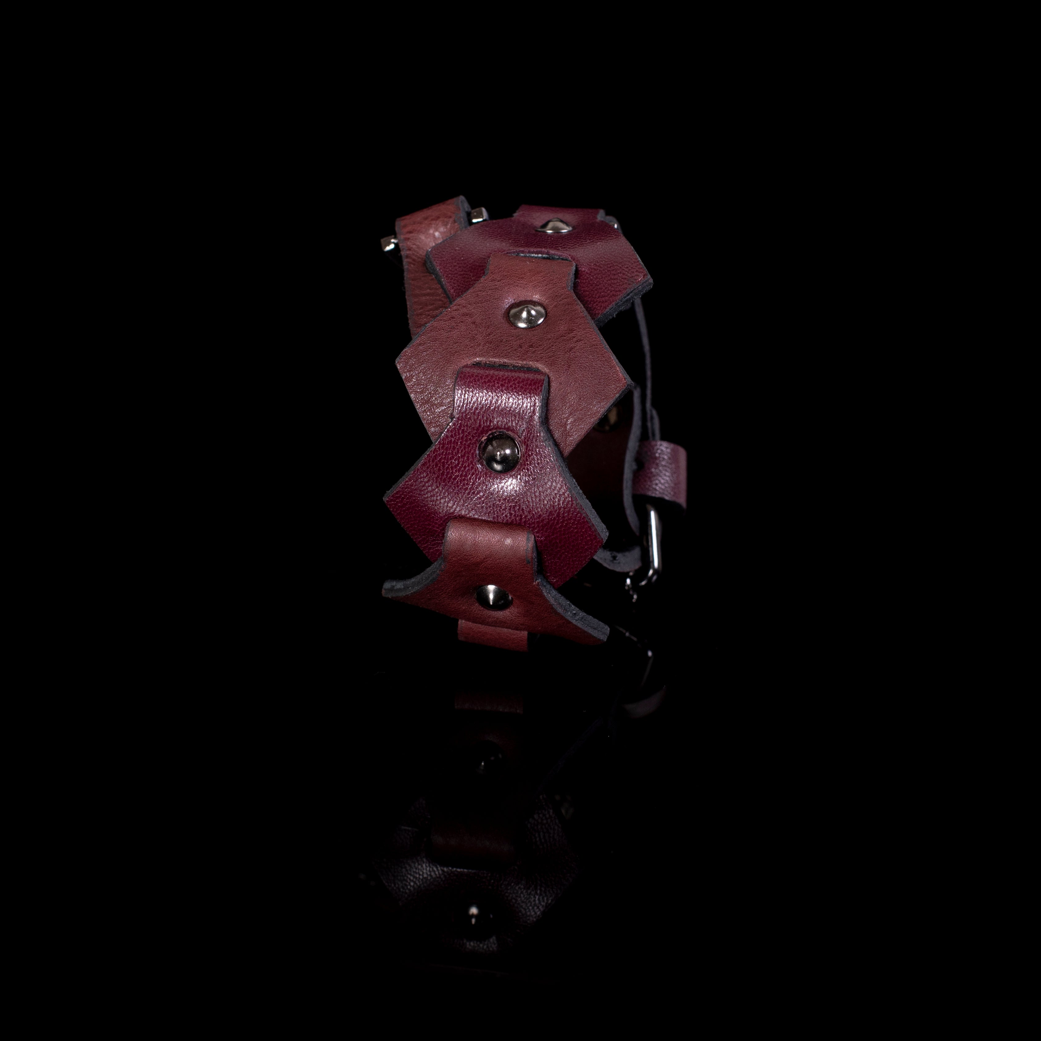 Burgundy leather cuff bracelet with layered geometric panels and metal studs, handcrafted wide statement bracelet for women