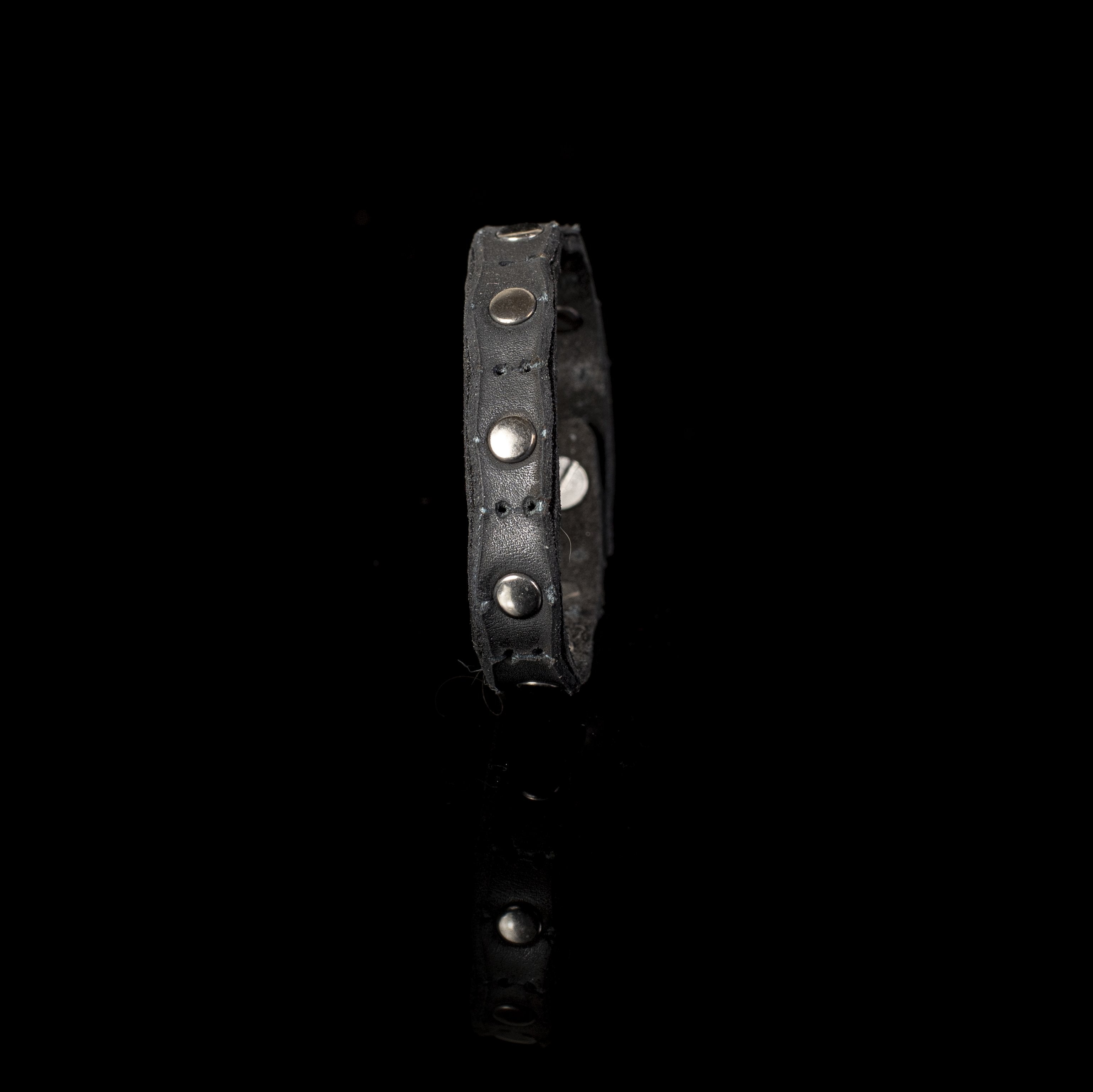 Handmade black leather bracelet featuring polished metal studs and an adjustable snap closure.