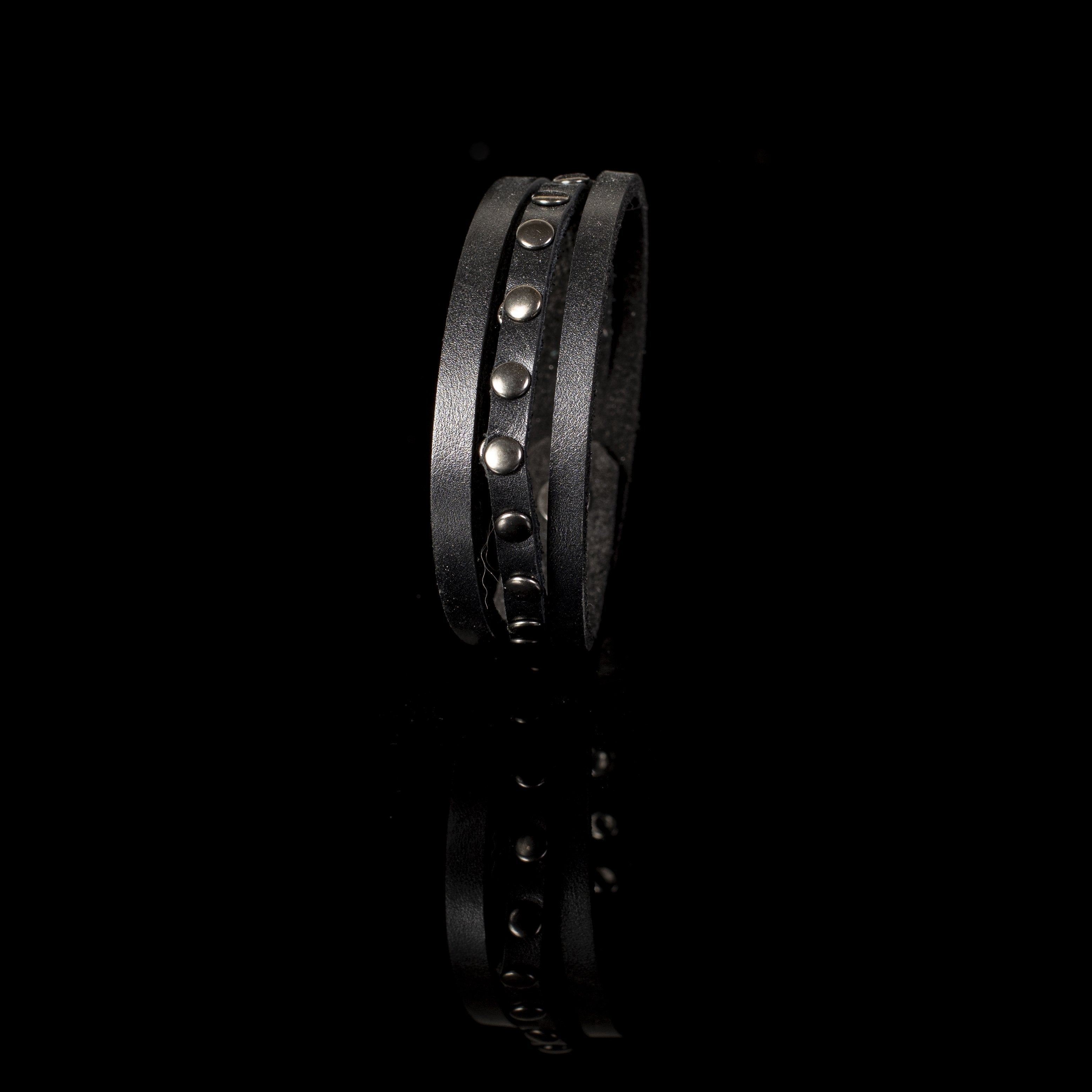 Handmade black double-wrap leather bracelet featuring gunmetal studs and a secure snap closure.