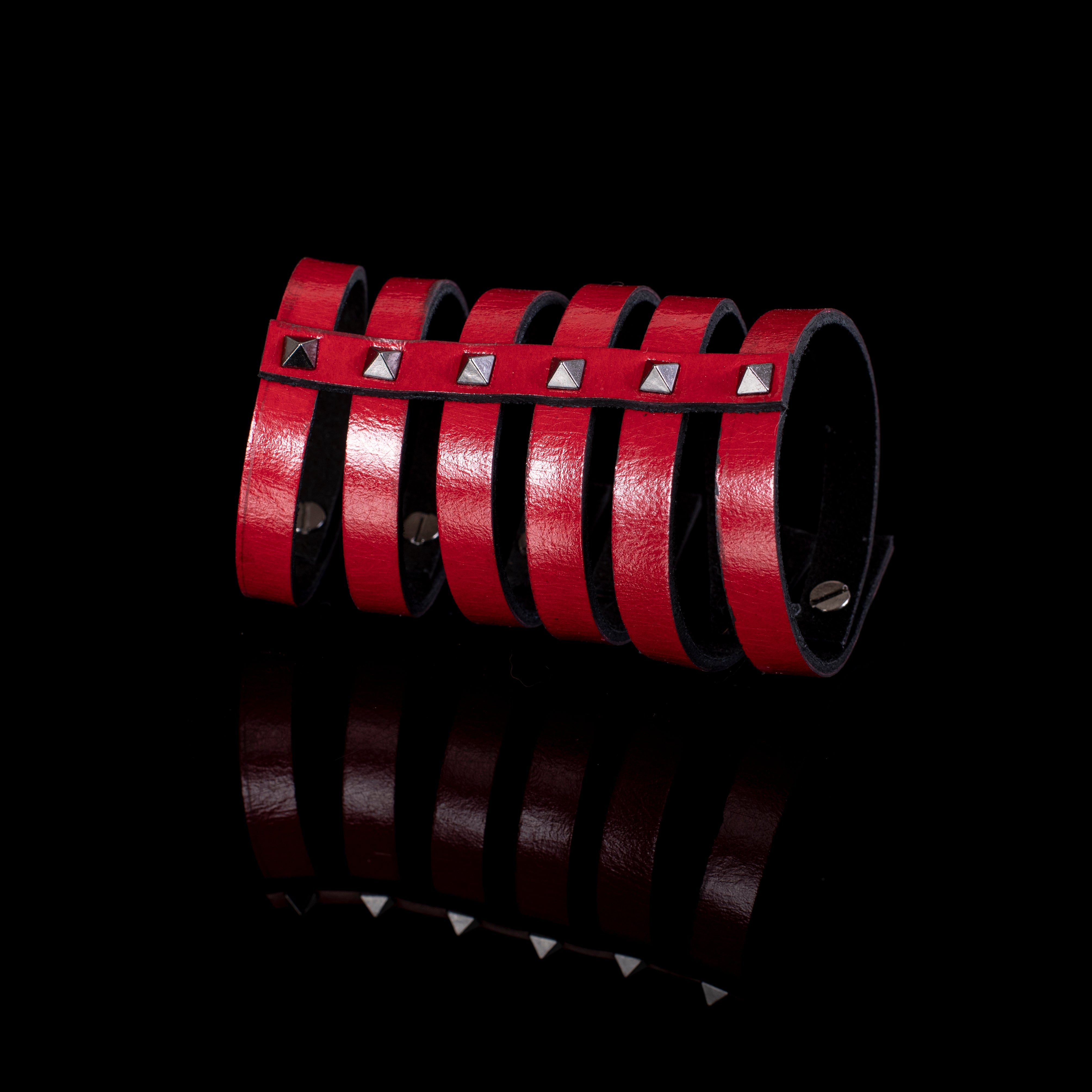 Red leather multi-strap cuff bracelet with silver pyramid studs and black interior lining, handcrafted structured statement bracelet for women by THE DARK