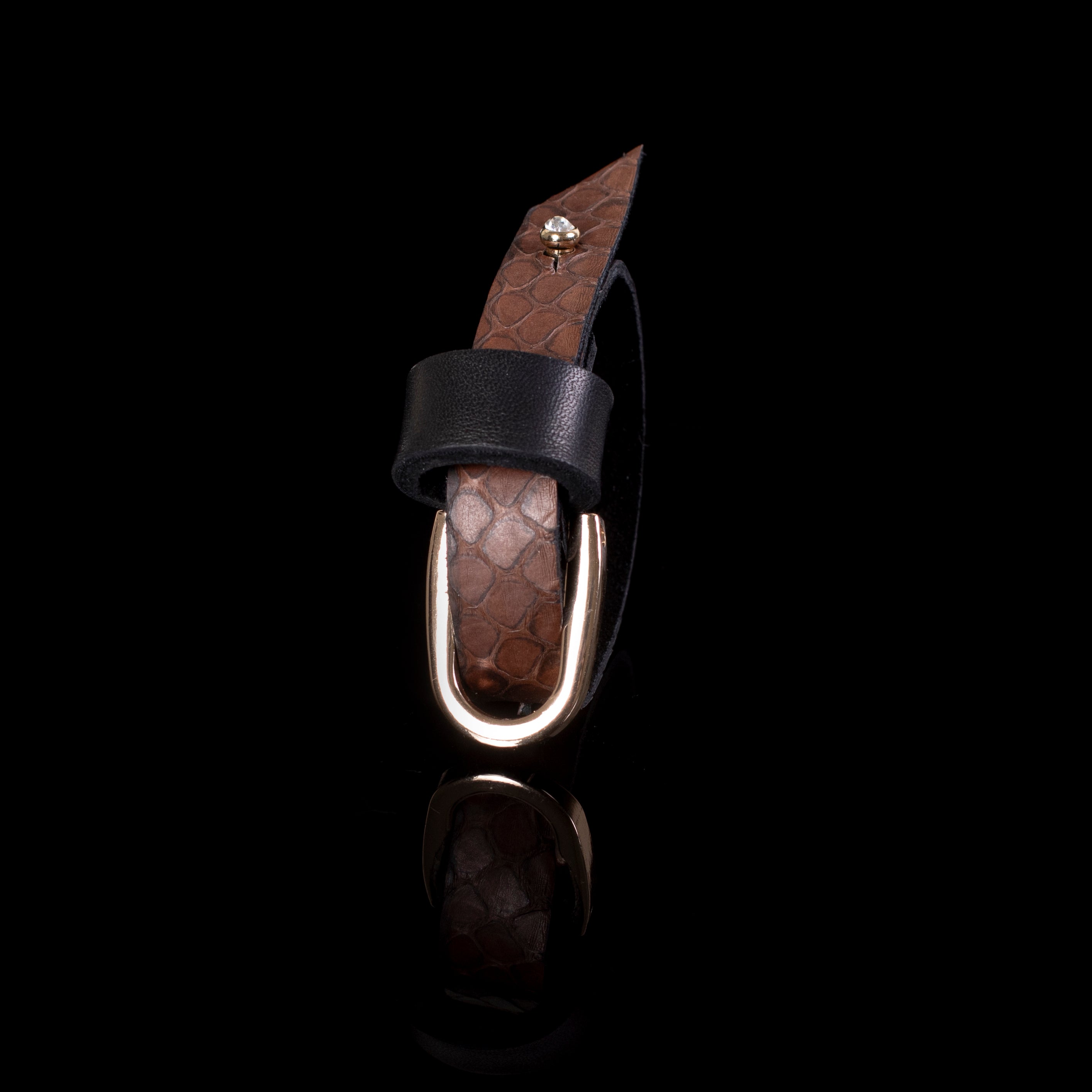 Brown textured leather cuff bracelet with black strap and gold ring detail, layered minimalist statement bracelet for women