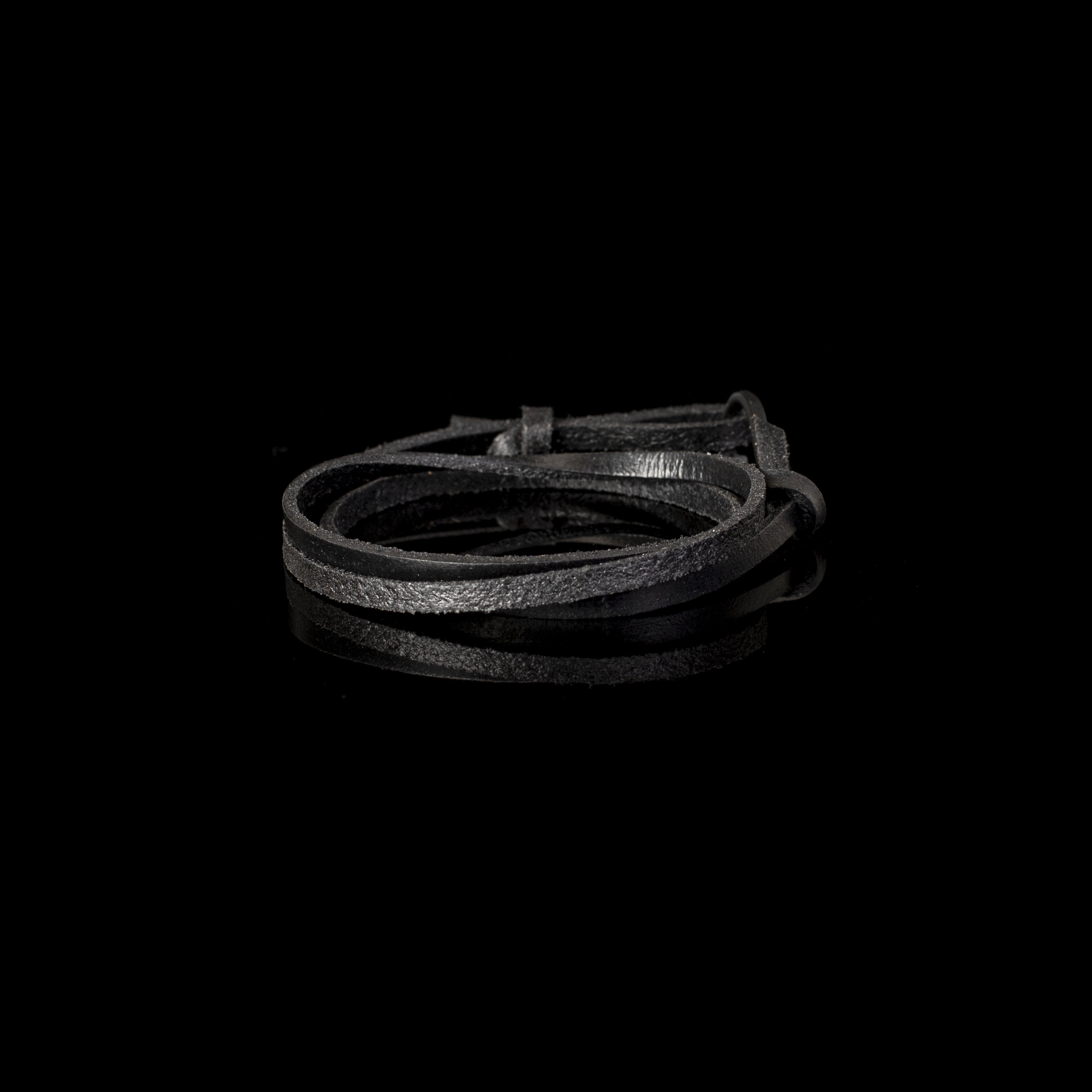 Handmade black leather wrap bracelet featuring multiple leather strands and a black hook clasp in a minimalist design.