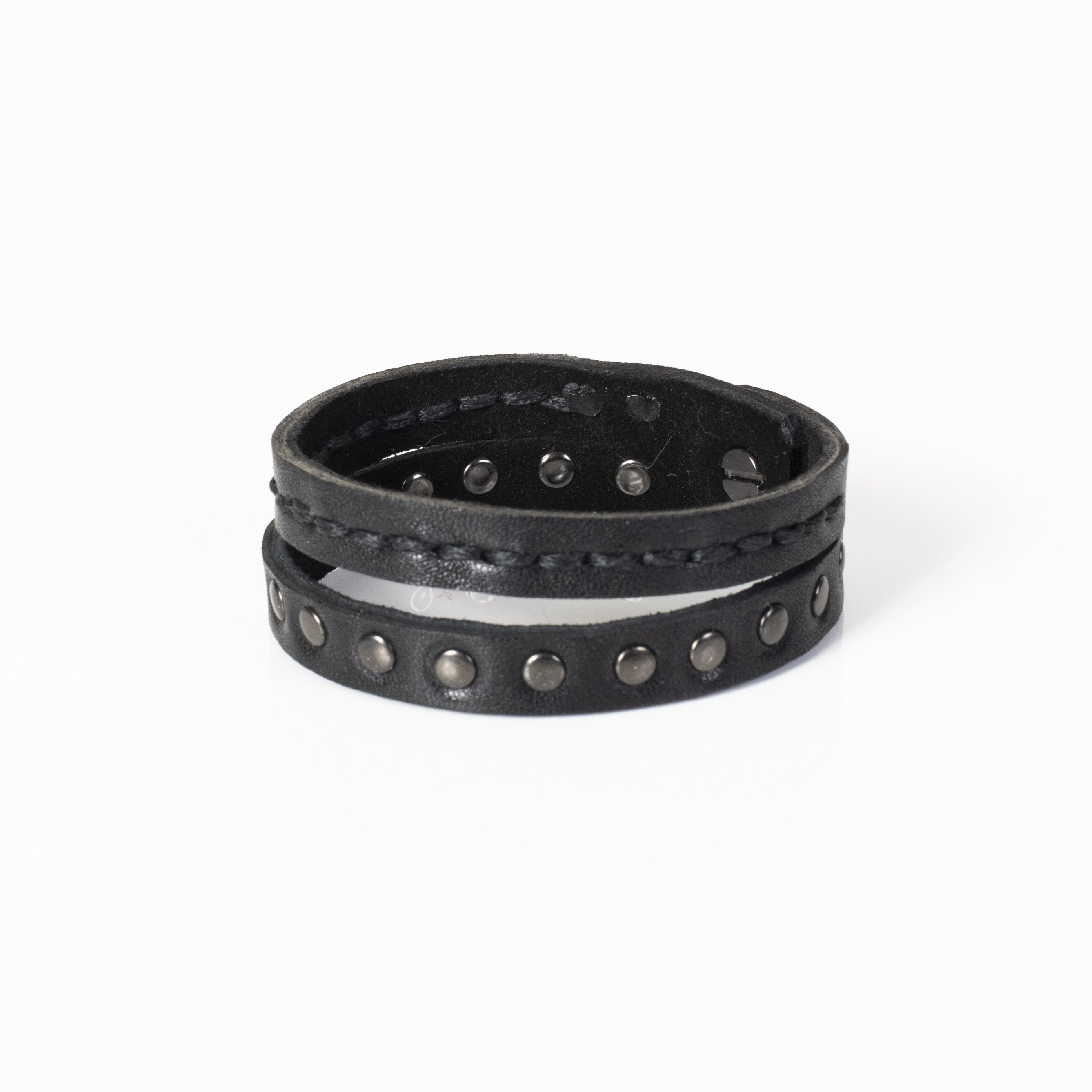 Men's double-wrap black genuine leather bracelet featuring hand-stitched detailing and gunmetal stud accents on a white background.