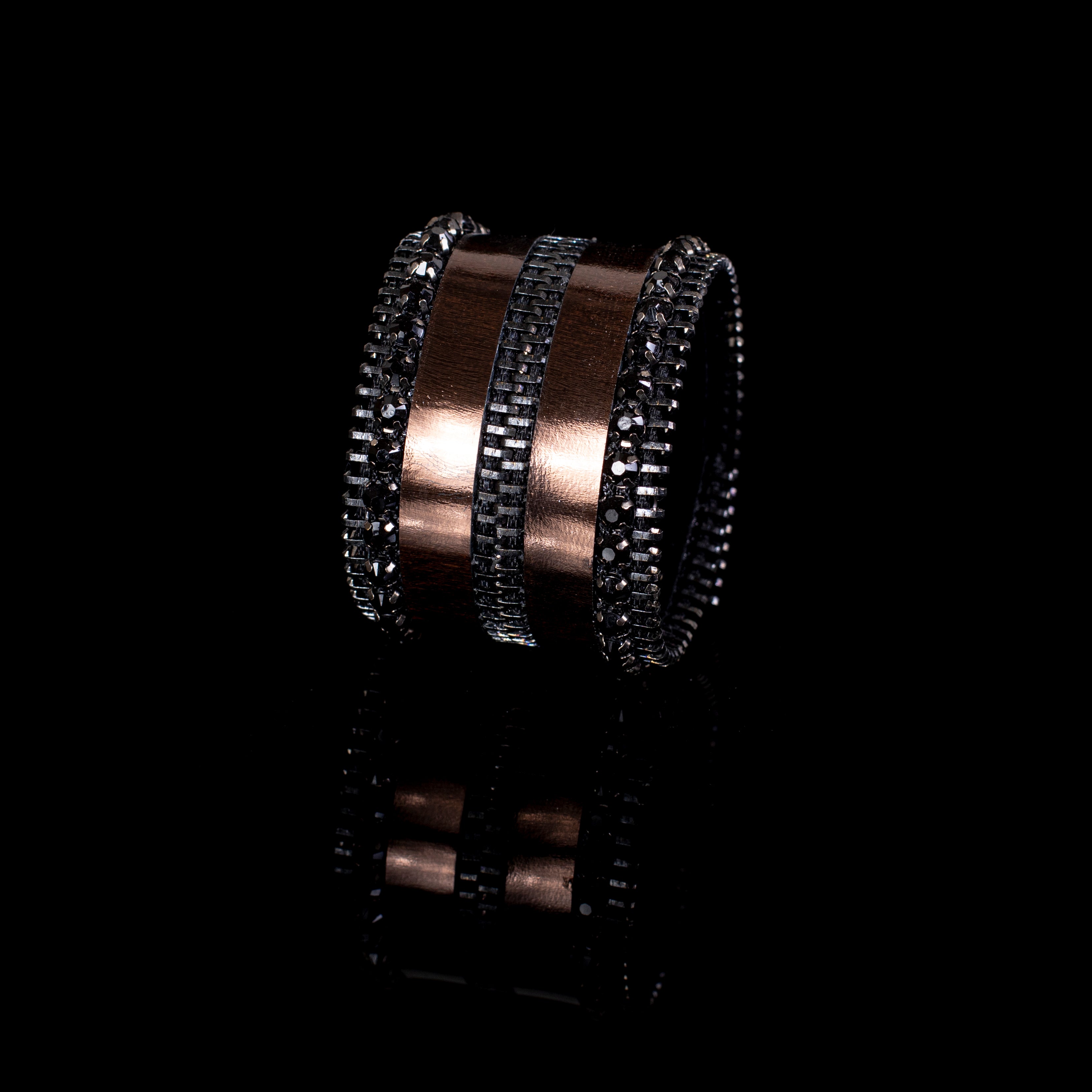 Black leather cuff bracelet with bronze metallic bands, black crystals and zipper edge detail, wide handcrafted statement bracelet for women