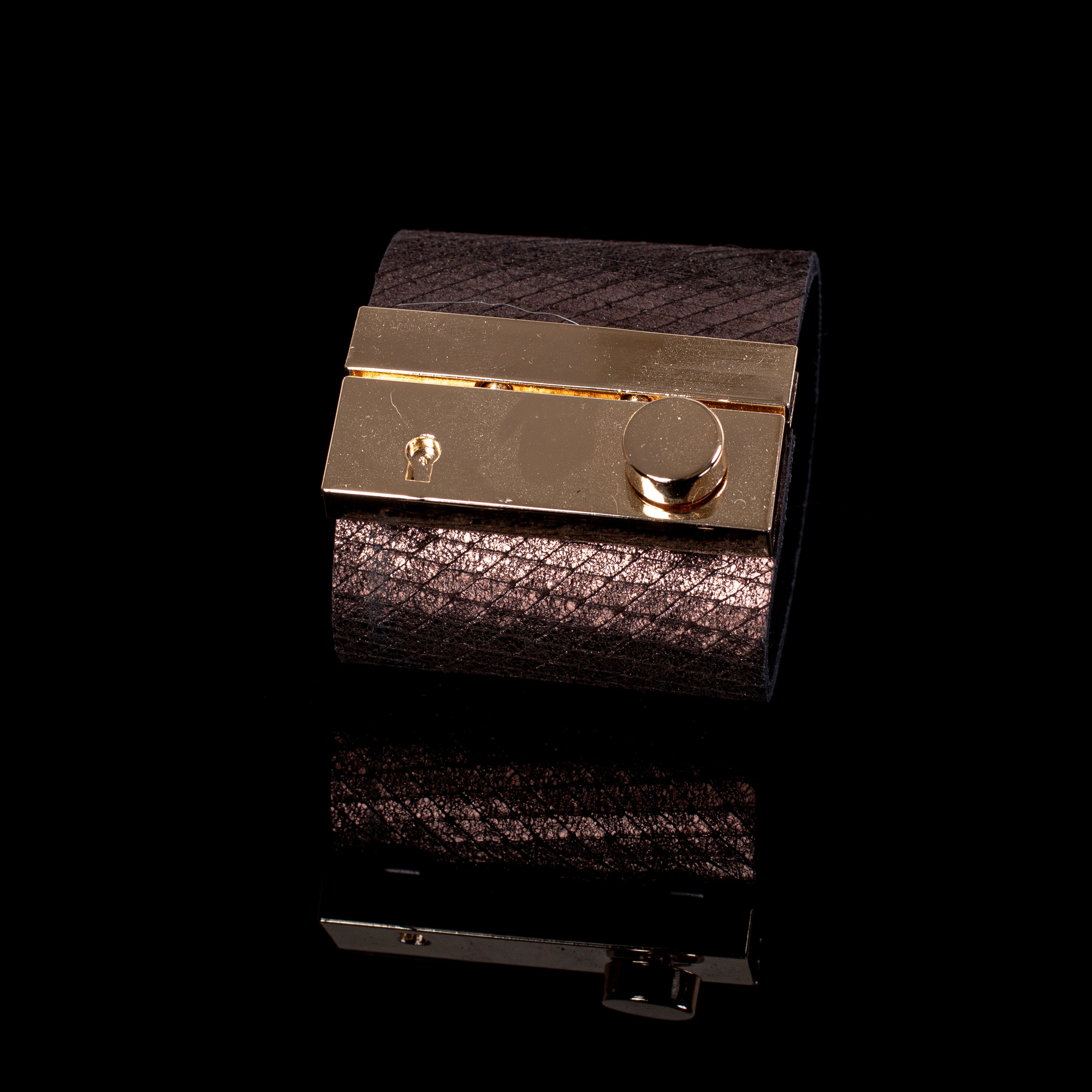 wide bronze leather cuff bracelet with polished gold plate and minimal lock detail statement design
