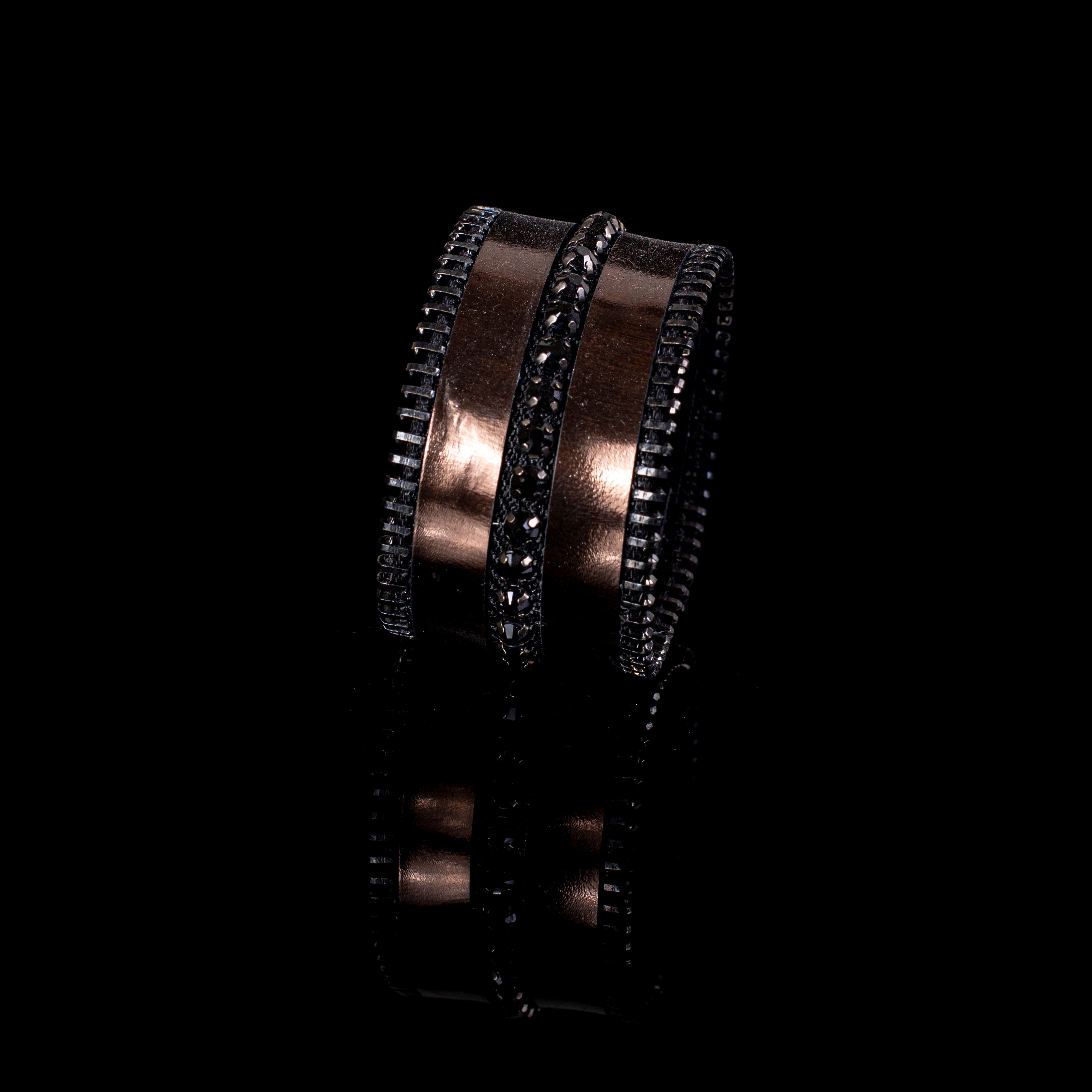 Wide black leather cuff bracelet with metallic bronze bands, black crystal strip and zipper edge detail, handcrafted statement bracelet for women