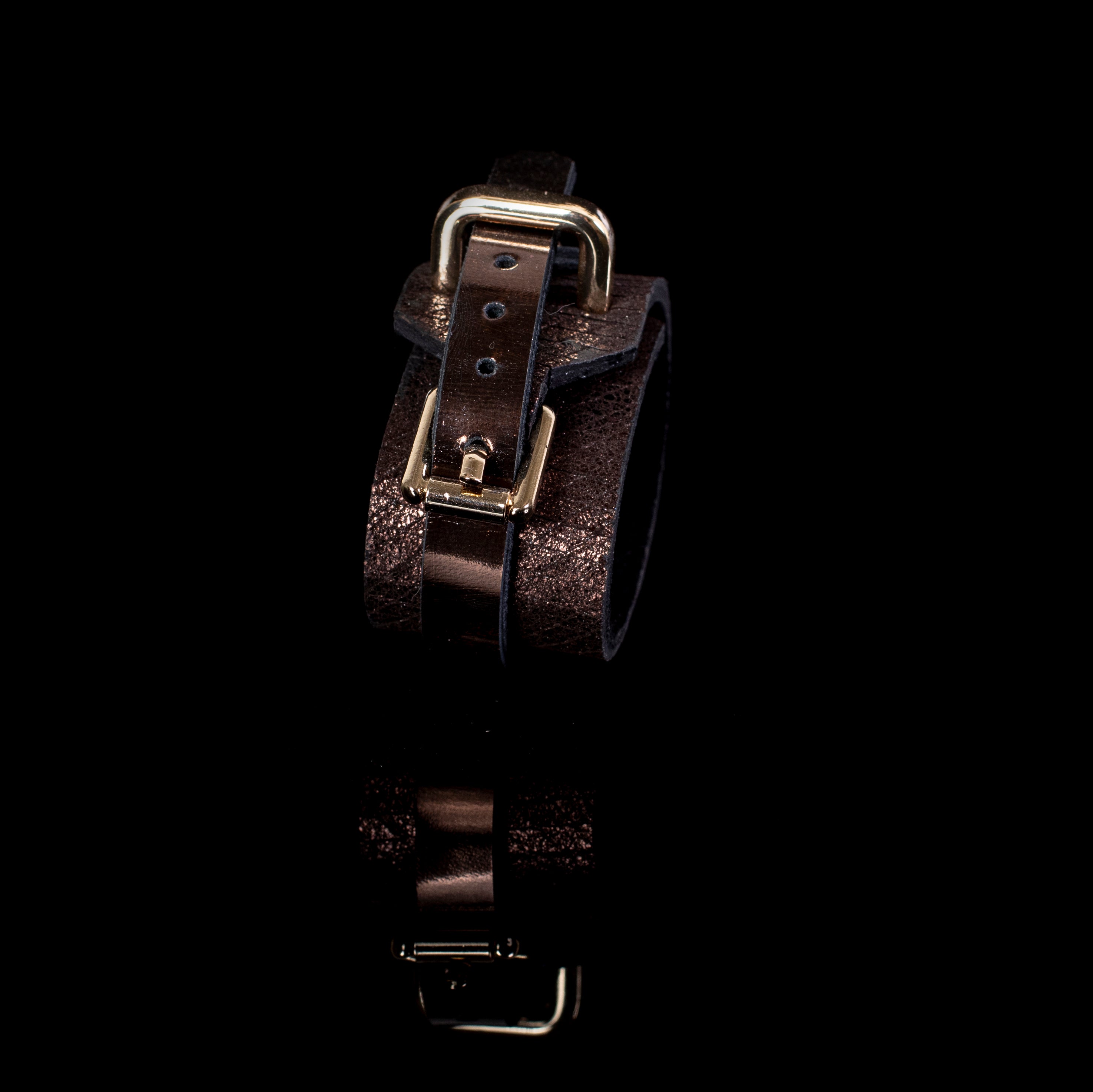 brown leather cuff bracelet with gold buckle closure and metallic bronze textured finish wide statement design