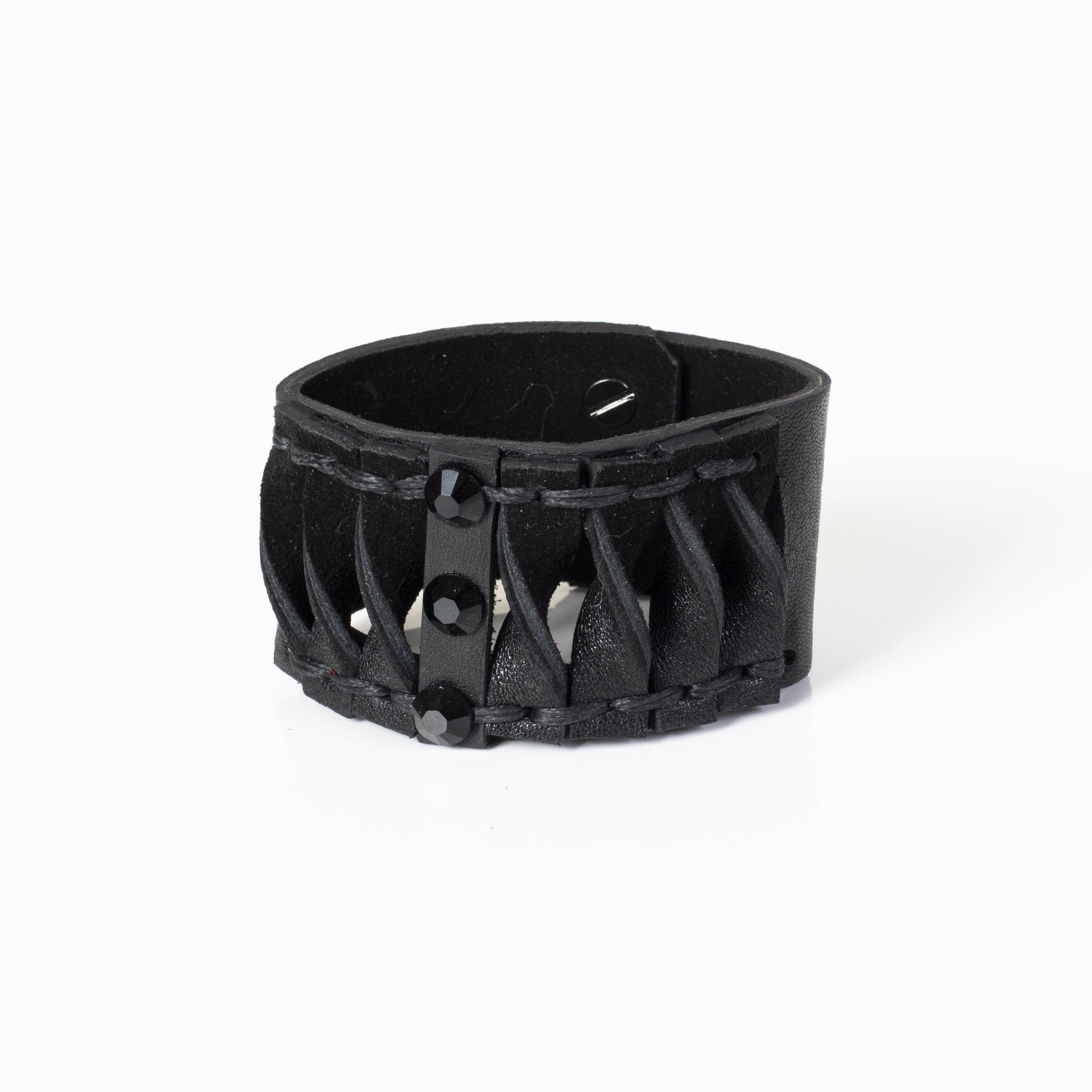 Handmade black leather cuff bracelet featuring lace-up detailing and faceted black crystals in a gothic statement design for men.