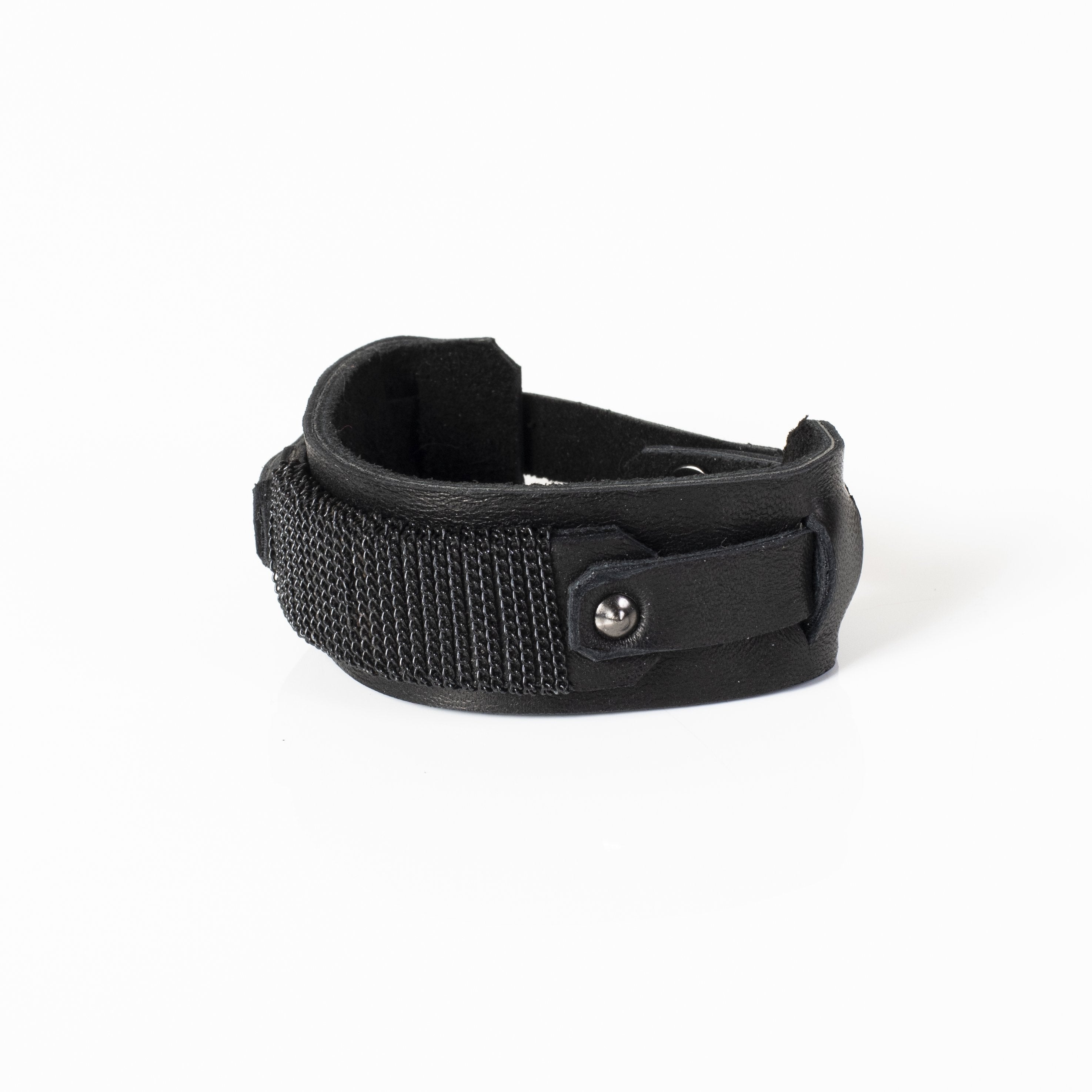 Handmade black leather cuff bracelet featuring an industrial buckle design and textured black mesh detail for men.