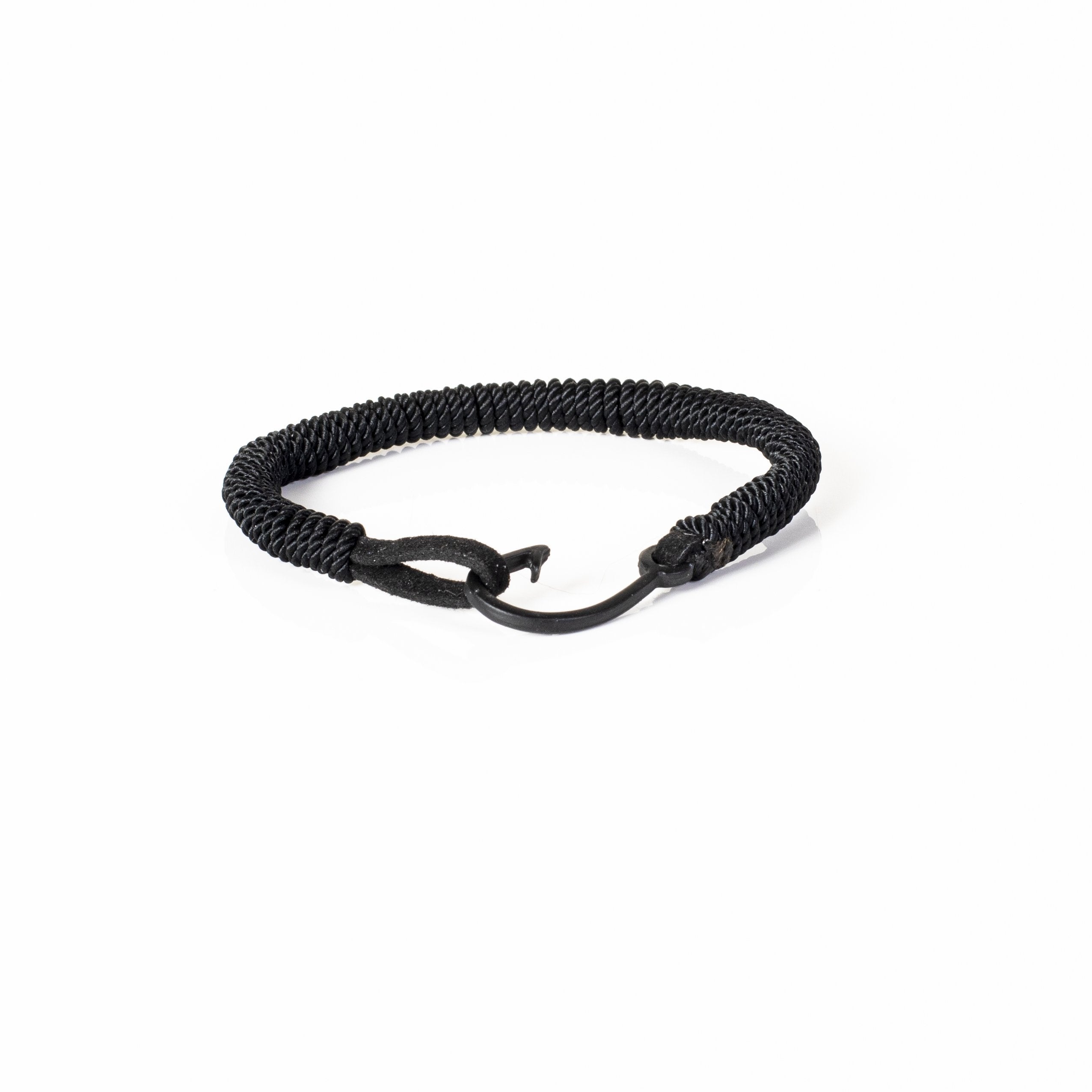 Handmade black coiled leather bracelet featuring a tightly wrapped spiral leather design with minimalist handcrafted detailing.