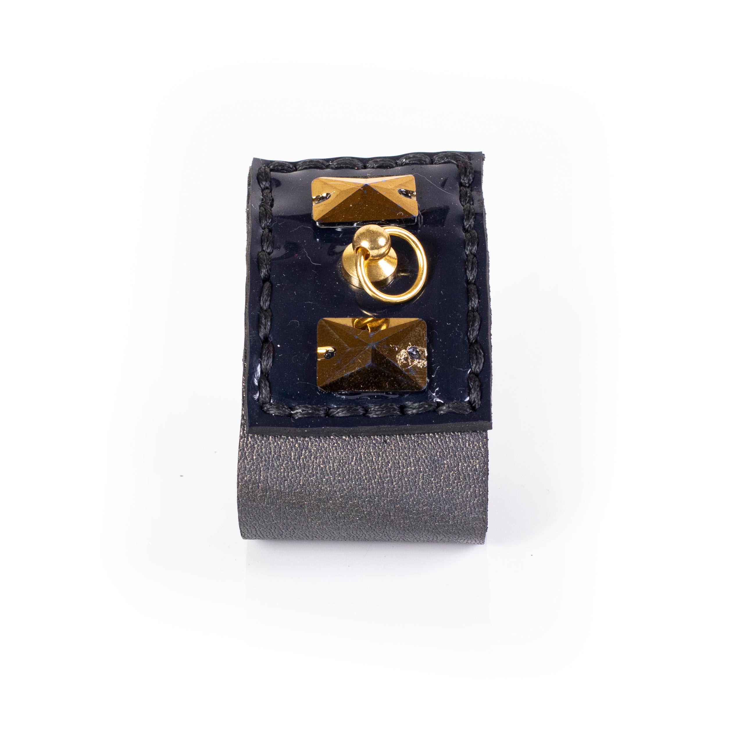 Wide black leather cuff bracelet with gold pyramid studs and central ring detail, bold statement bracelet for women