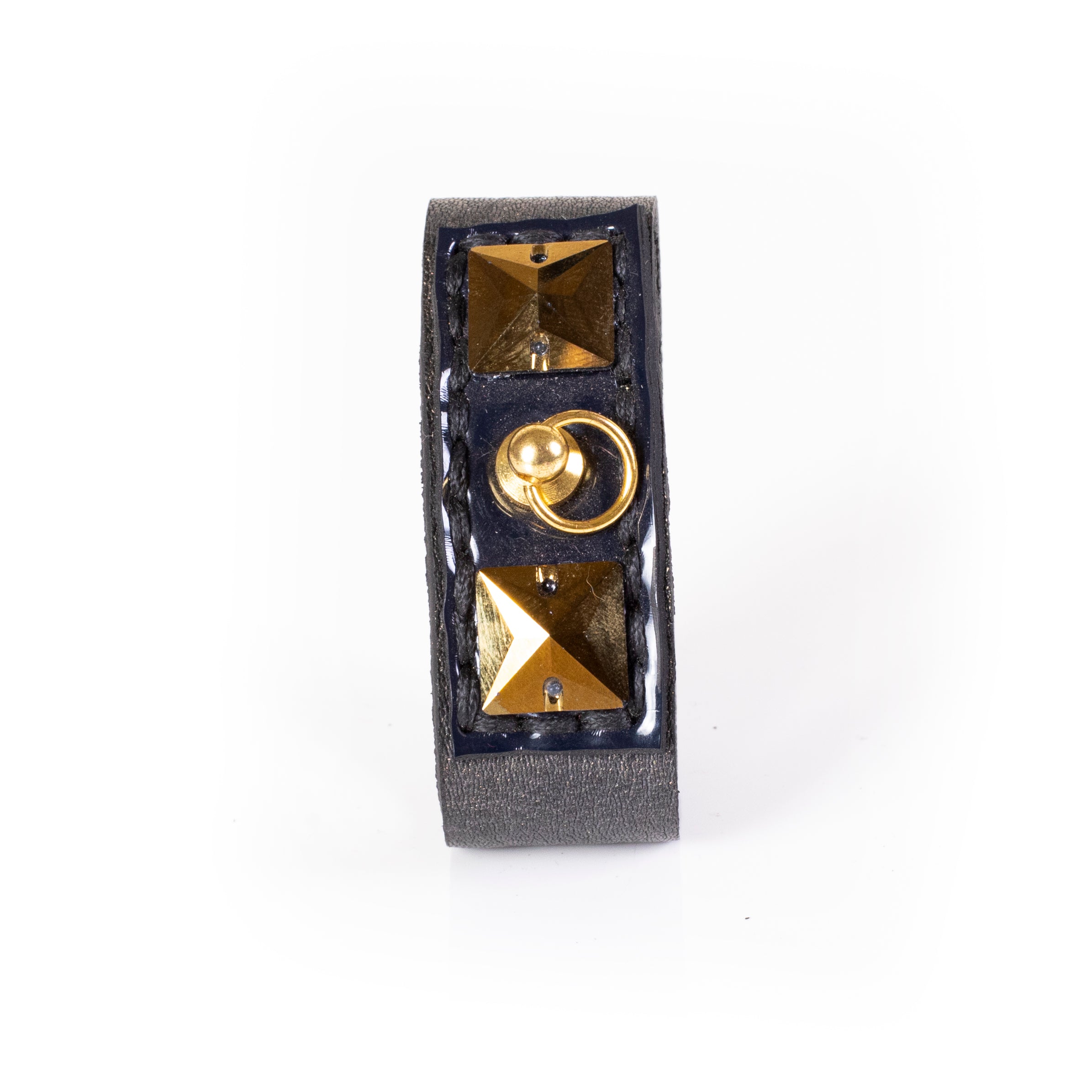 Slim black leather cuff bracelet with gold pyramid studs and central ring detail, narrow statement bracelet for women