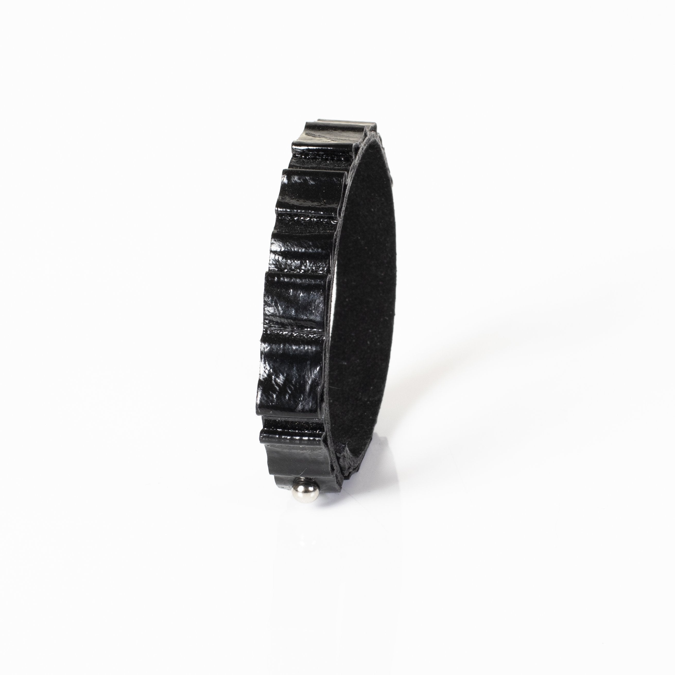 Handmade black crocodile embossed leather bracelet with textured reptile pattern and minimalist cuff design.
