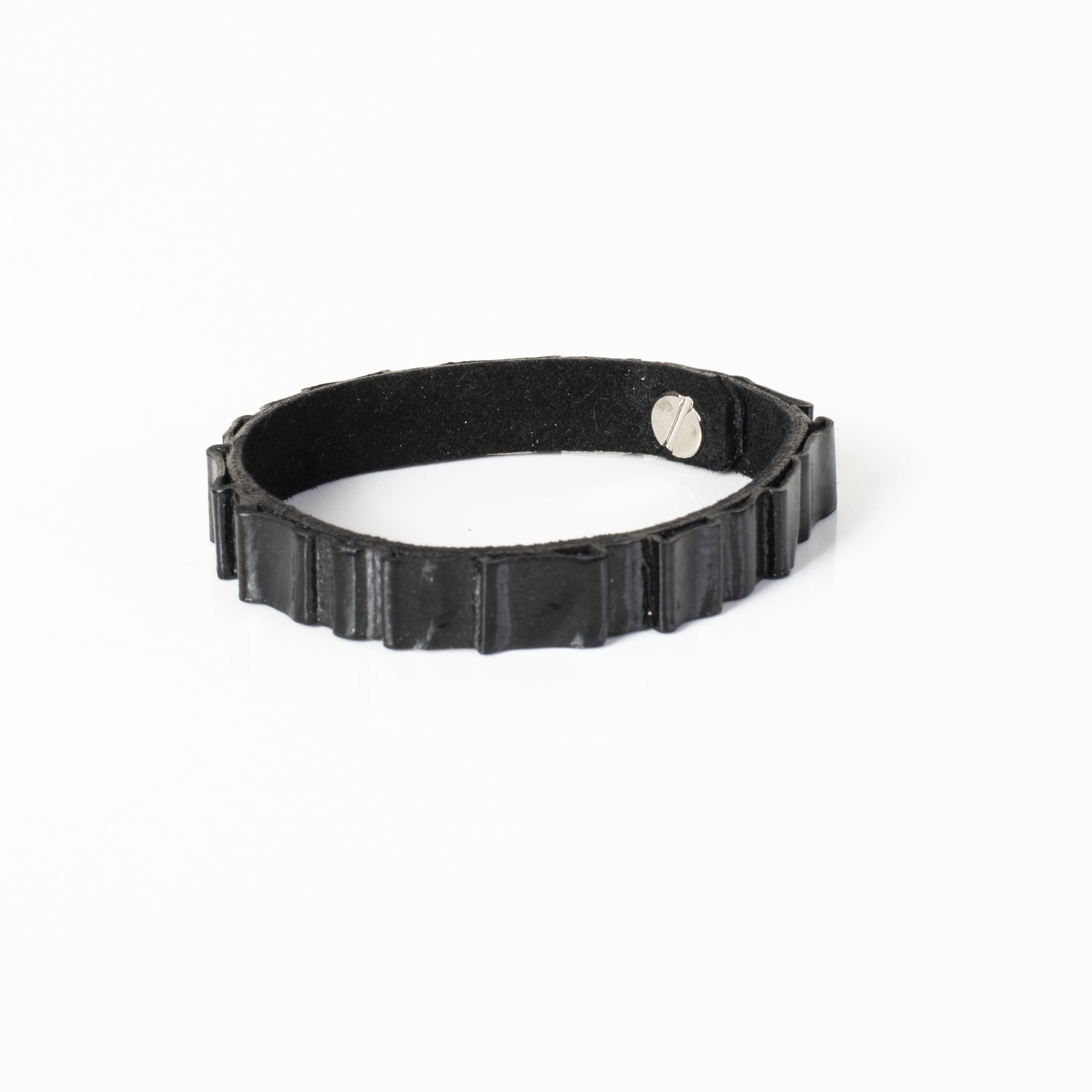 Handmade black crocodile embossed leather bracelet with textured reptile pattern and minimalist cuff design.