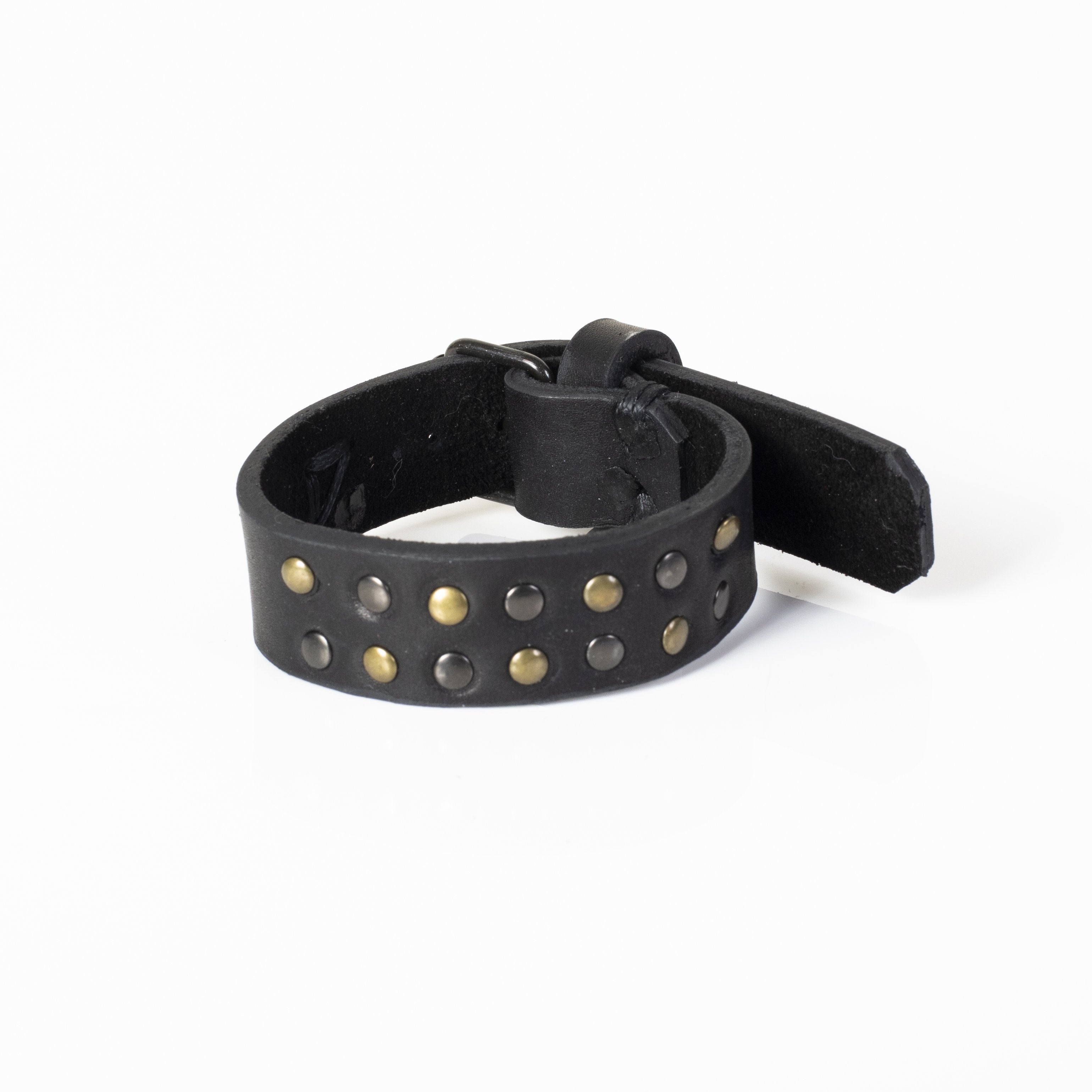 Handmade black leather cuff bracelet featuring antique brass and gunmetal studs with a wide statement design.