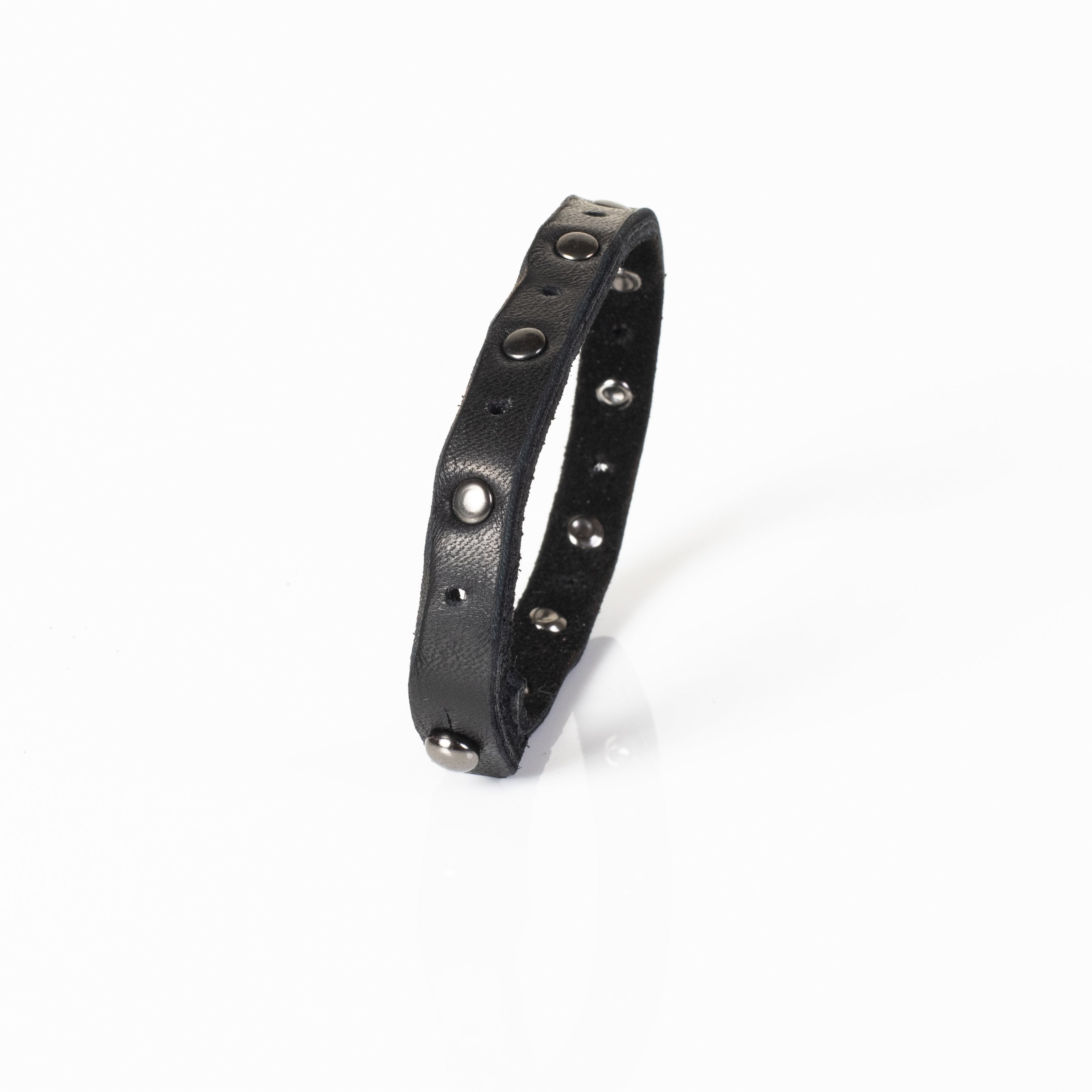 Handmade slim black leather bracelet featuring matte gunmetal studs and a secure snap closure.