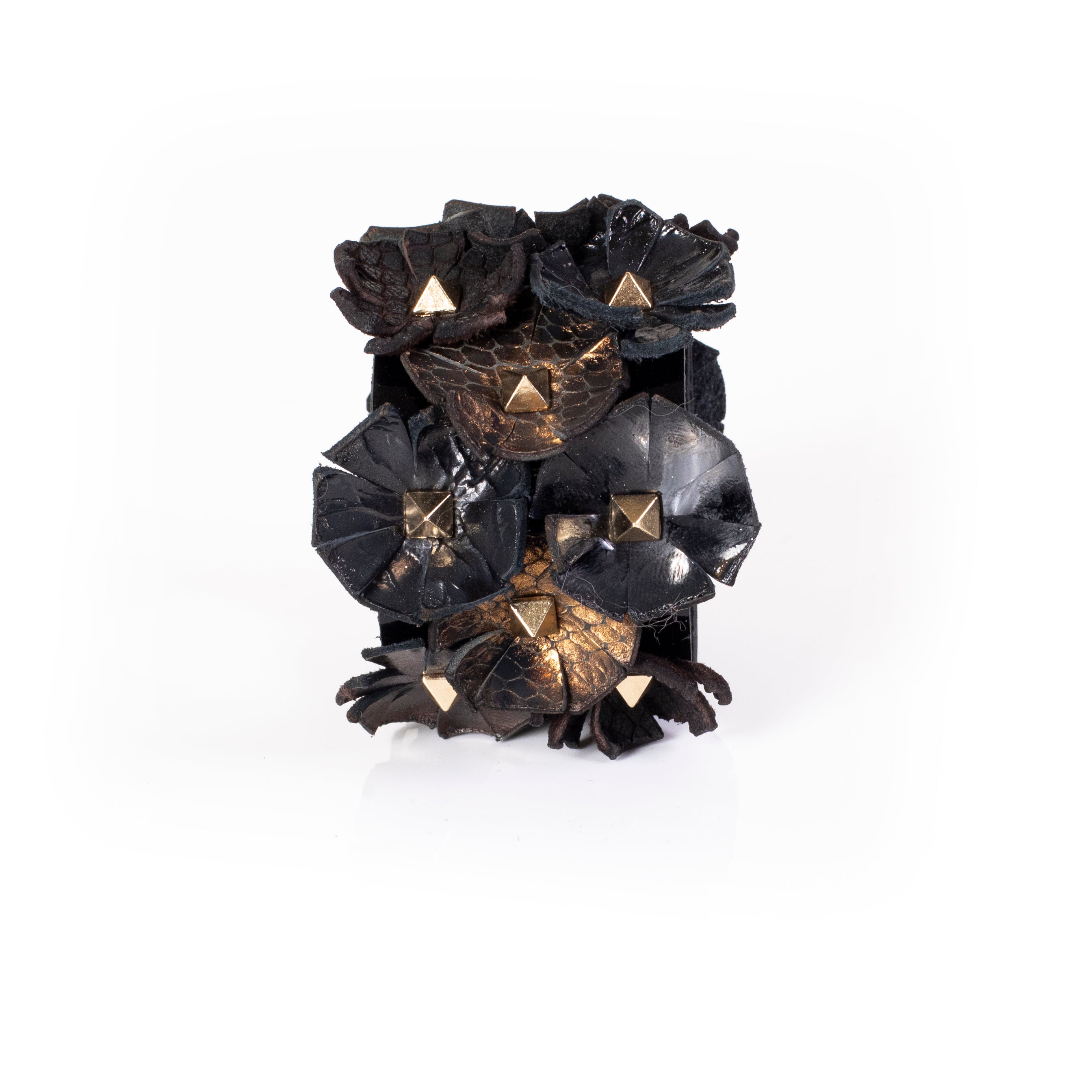 Black leather cuff with multiple sculpted floral elements and gold pyramid studs