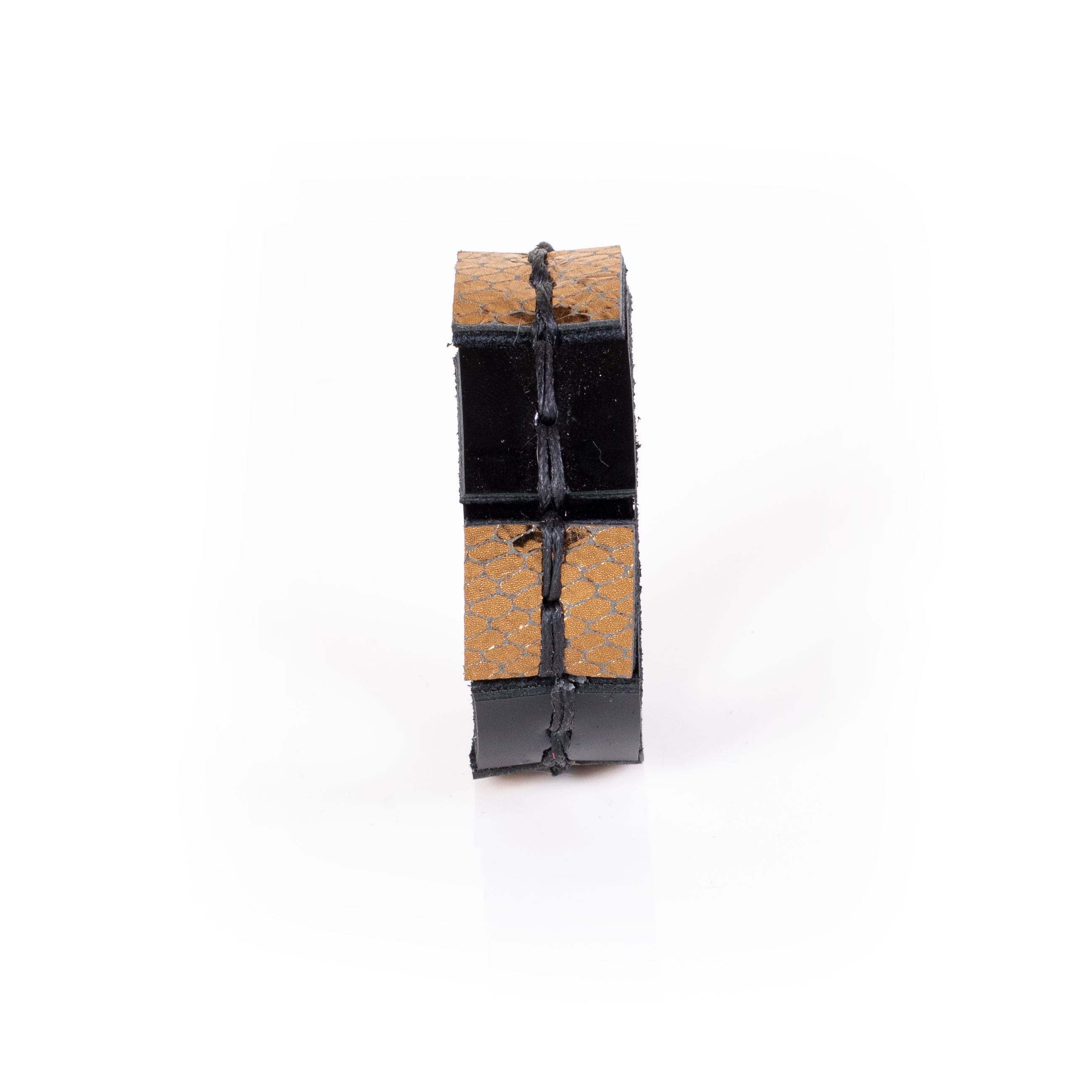 Black leather cuff bracelet with gold python textured panels and visible hand stitching, handcrafted structured statement bracelet for women by THE DARK