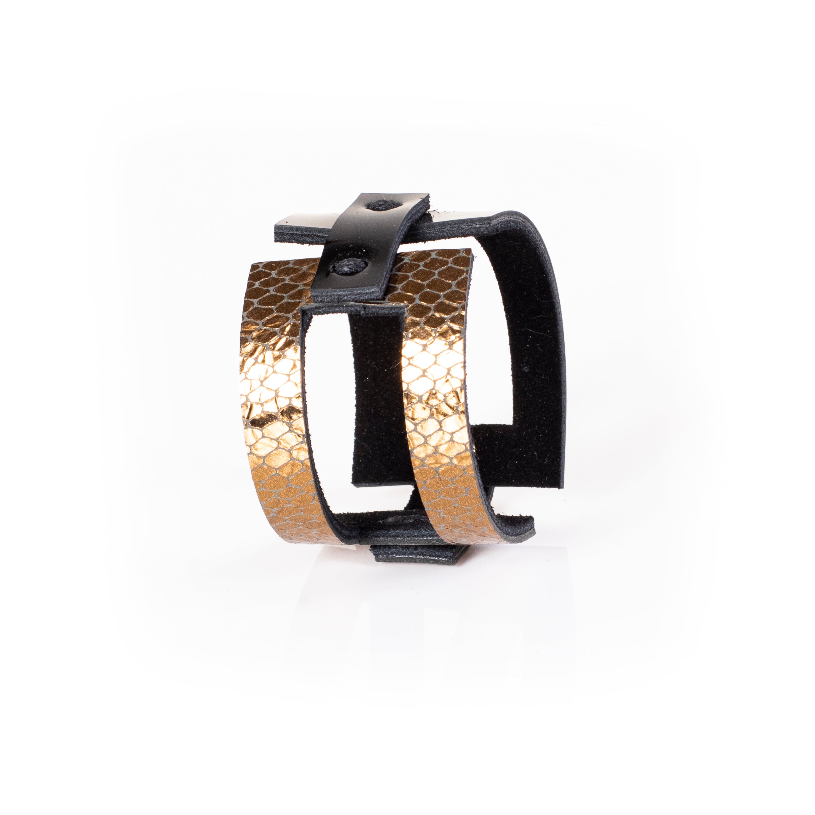 Black leather sculptural cuff bracelet with vertical gold python textured bands and open architectural design, handcrafted statement bracelet for women by THE DARK