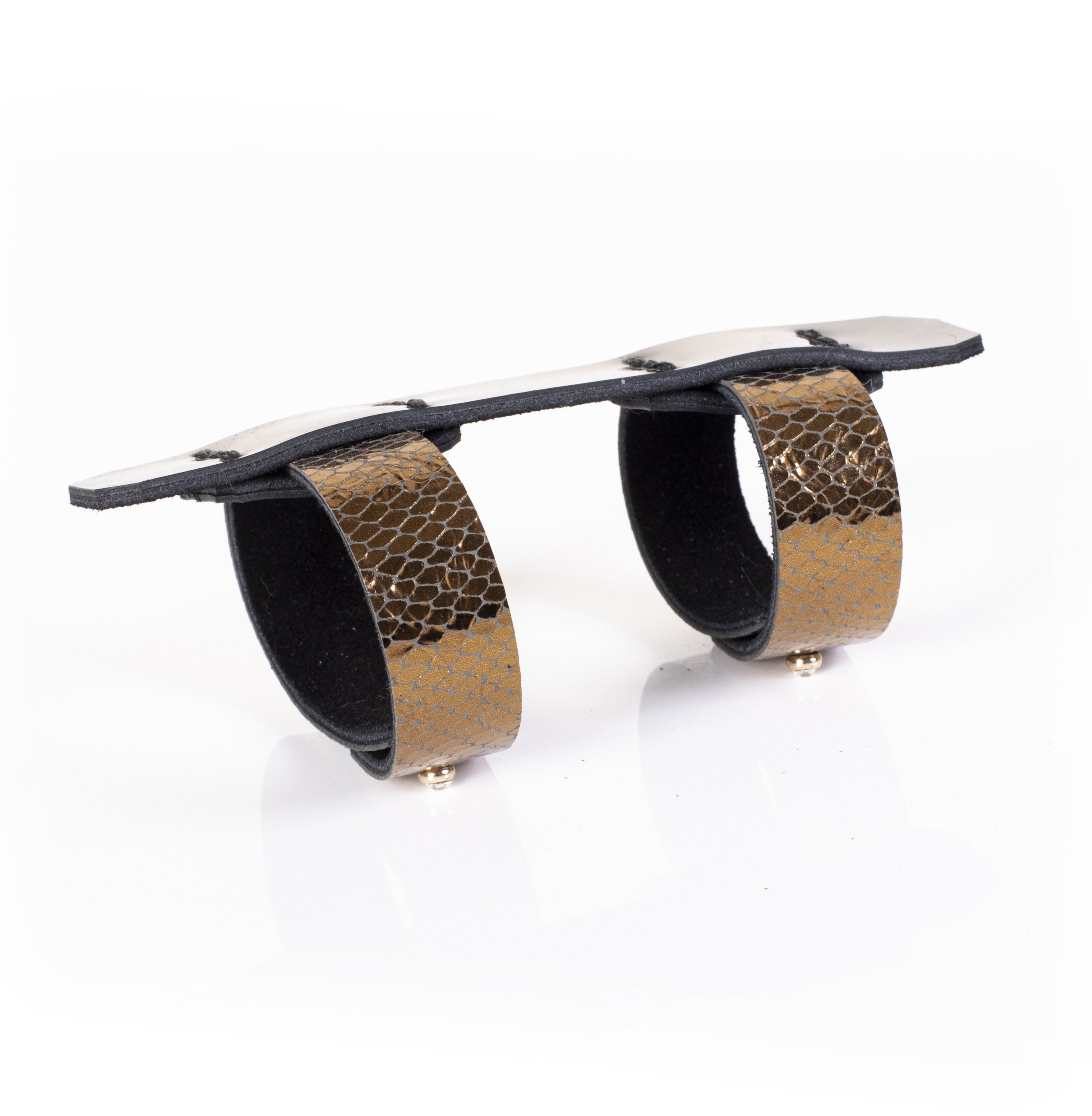 Black leather sculptural cuff bracelet with double ring design and gold python textured bands, handcrafted architectural statement bracelet for women by THE DARK