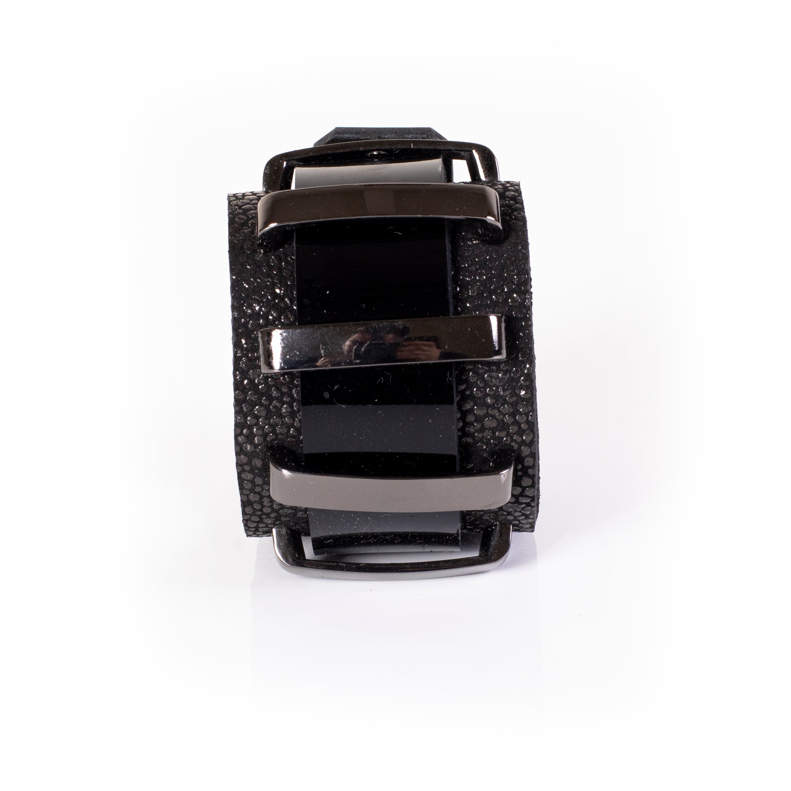 Black leather cuff bracelet with glossy panels and textured edges, wide structured bracelet with metal bar detail for women