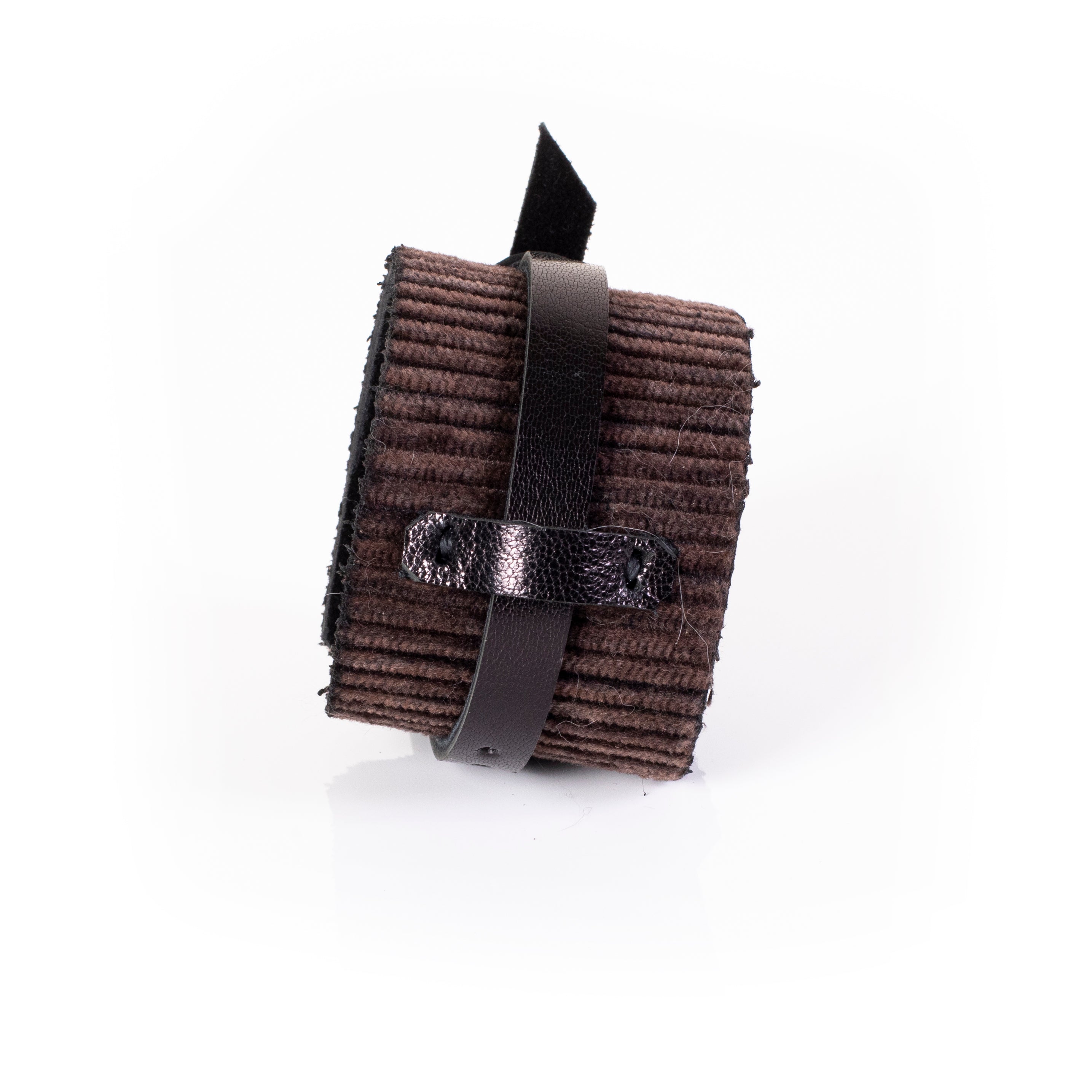 Brown ribbed leather cuff bracelet with central wrap strap detail and wide textured surface, handcrafted statement piece