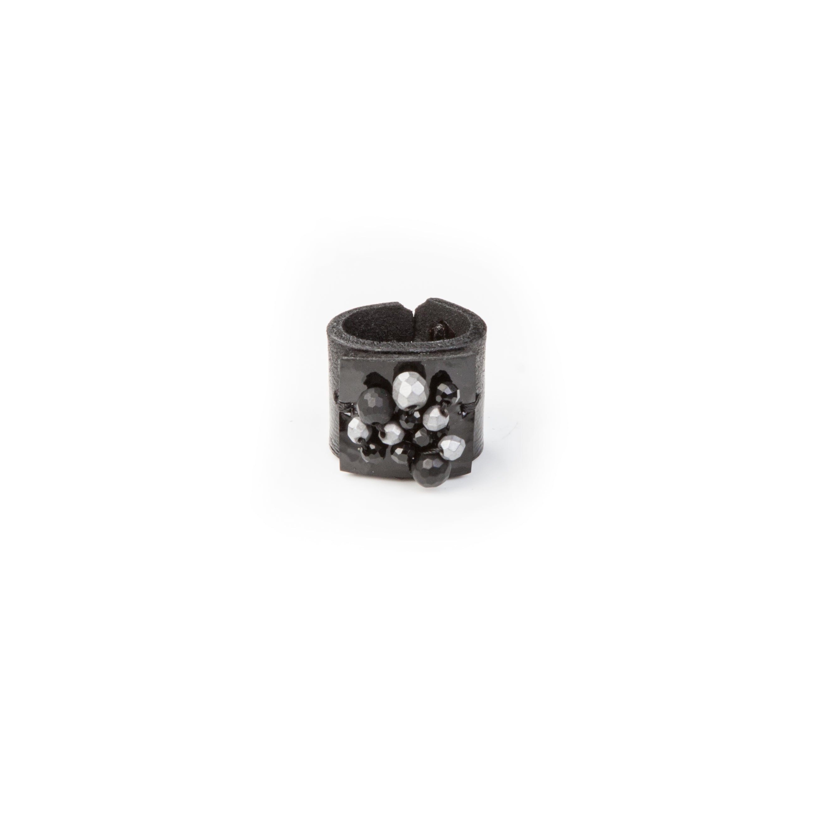 Handmade black leather statement ring with black and silver crystal cluster detail on white background