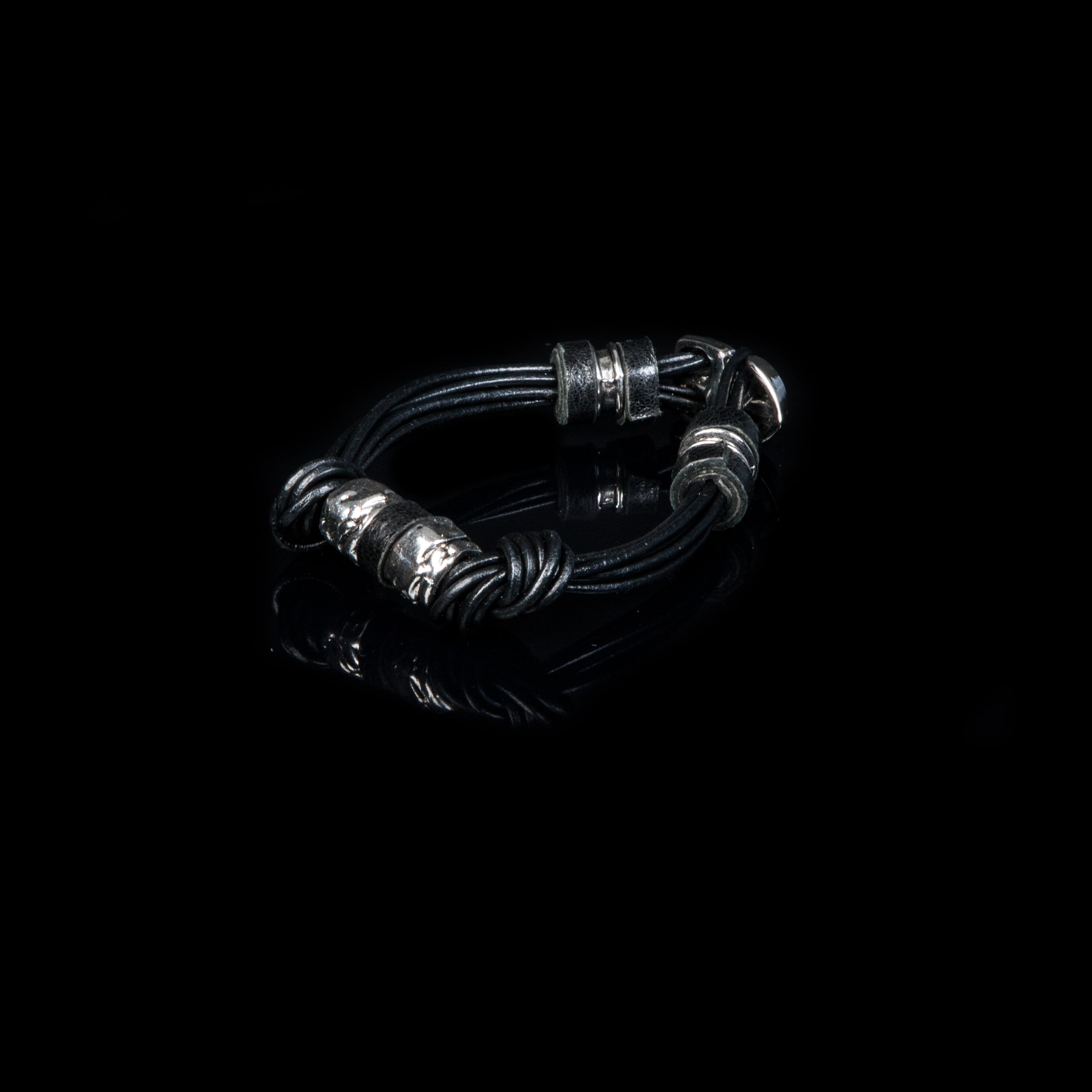 Black multi-strand leather bracelet with knot details and silver-tone accents on white background
