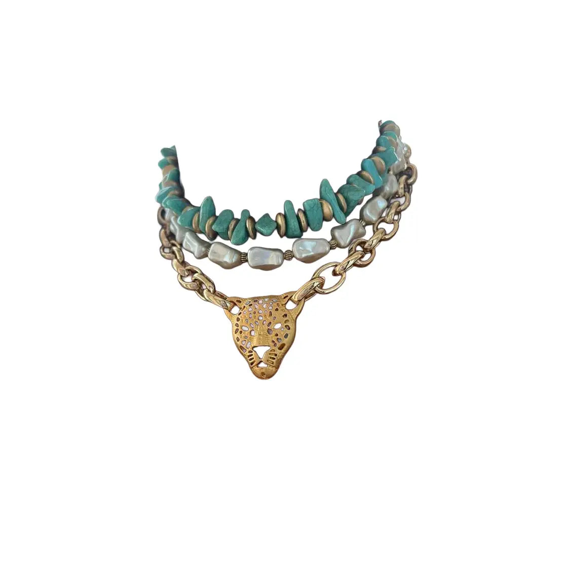 Layered turquoise and pearl necklace with gold chain and leopard head pendant on a white background.