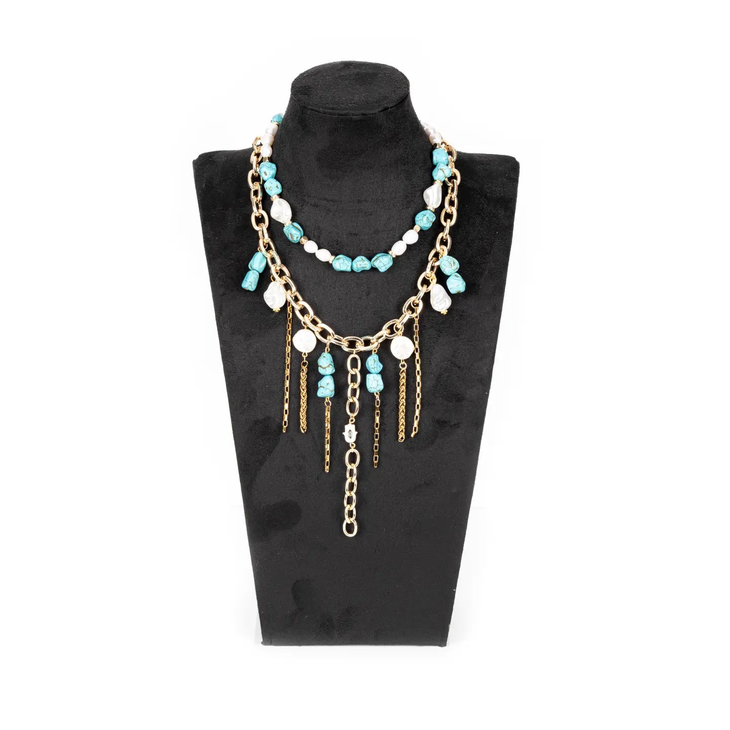 Layered turquoise and white beaded necklace with gold chain details and dangling chain accents on a white background.