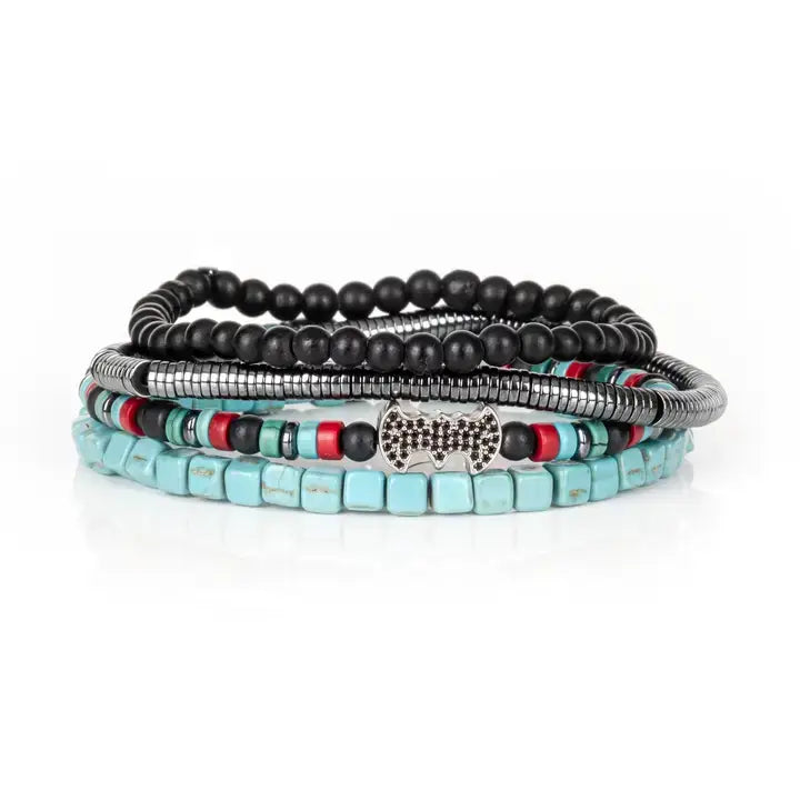 Black multi-layer men’s bracelet featuring matte black beads, turquoise cube beads, metallic hematite strands, red accent details, and crystal centerpiece accent on a light background.