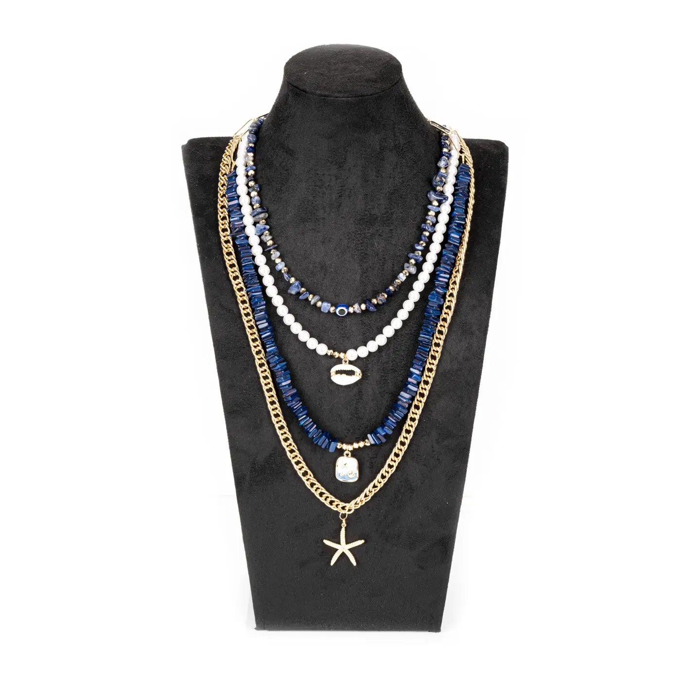 Layered blue and white bead necklace with gold chain and starfish pendant on white background.