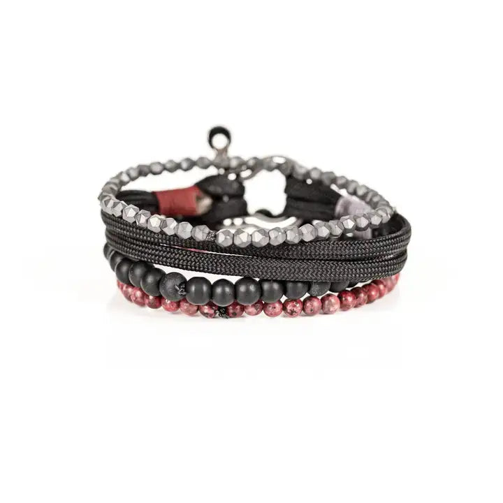 Black and red multi-layer men’s bracelet featuring metallic hook clasp, braided black rope, faceted hematite crystals, matte black beads, and red marbled natural stone beads on a light background.