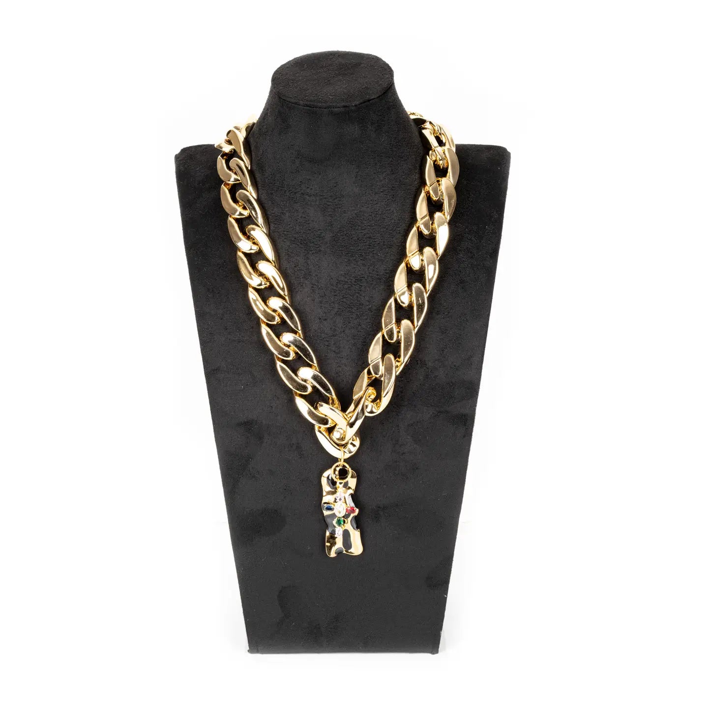 Gold chunky chain necklace with sculptural abstract pendant and subtle crystal accents on white background.