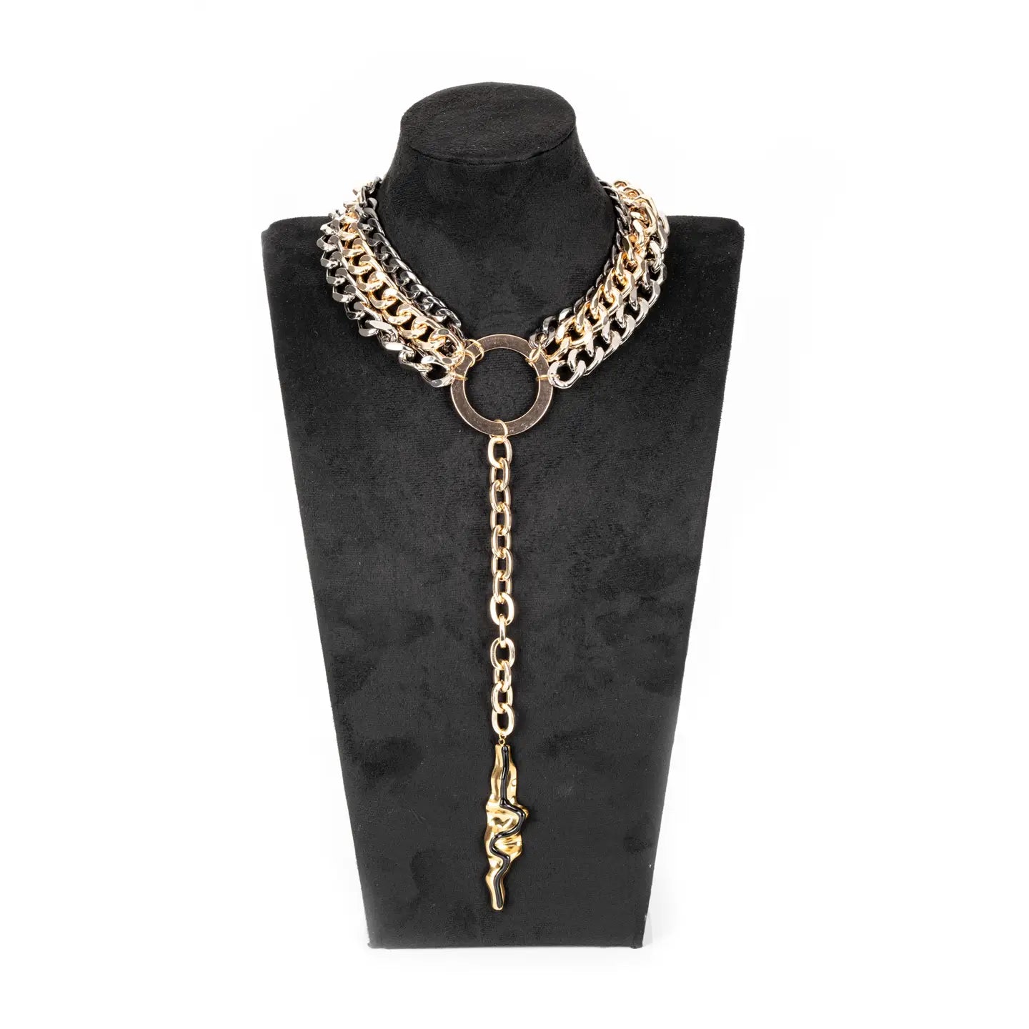 Mixed metal chain necklace with central ring and long drop pendant in gold and gunmetal tones on white background.