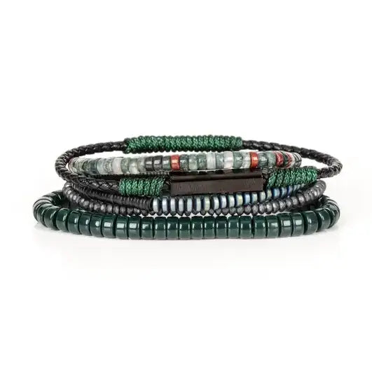Men’s layered bracelet set featuring dark green heishi beads, green woven cord, black braided leather, hematite spacer beads, and green-gray natural stone beads with subtle red accents, stacked in a sophisticated earthy luxury design on a white background.