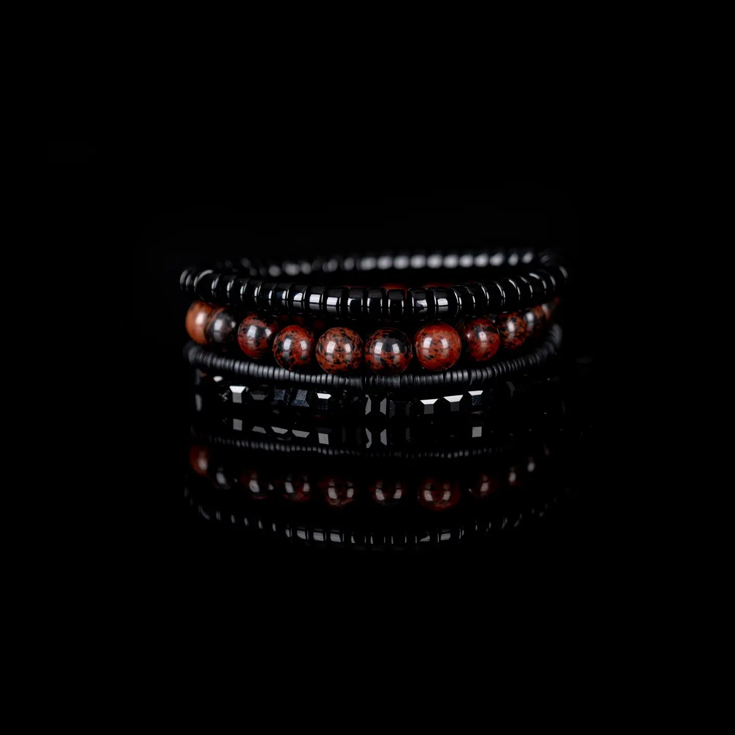 Men’s layered bracelet set featuring black lava stone disc beads, black braided cord wraps, white and gray marbled natural stone beads, black hematite coil beads, and light gray heishi beads, stacked in a sophisticated monochromatic luxury design on a white background.