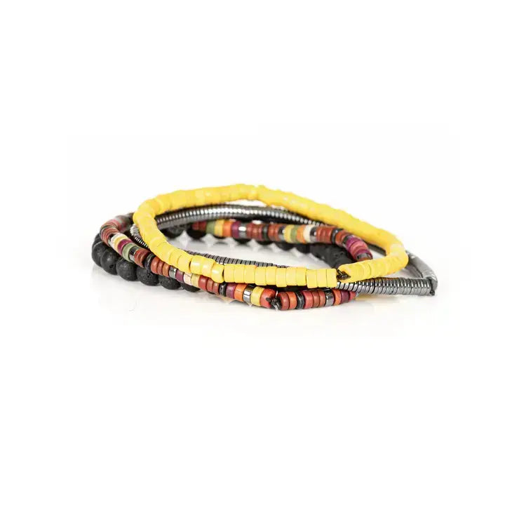 Men’s layered bracelet set featuring matte black lava stone beads, bright yellow heishi beads, multicolor tribal-inspired disc beads, a gunmetal pavé accent bead, and silver-tone coil wrap beads, stacked in a vibrant bohemian luxury design on a white background.