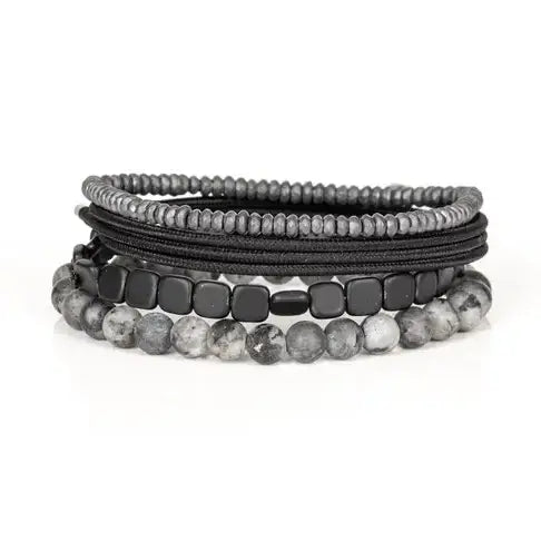 Men’s layered bracelet set featuring gray marbled natural stone beads, polished black hematite cube beads, black braided cord wraps, and silver-gray heishi beads, stacked in a sleek monochromatic luxury design on a white background