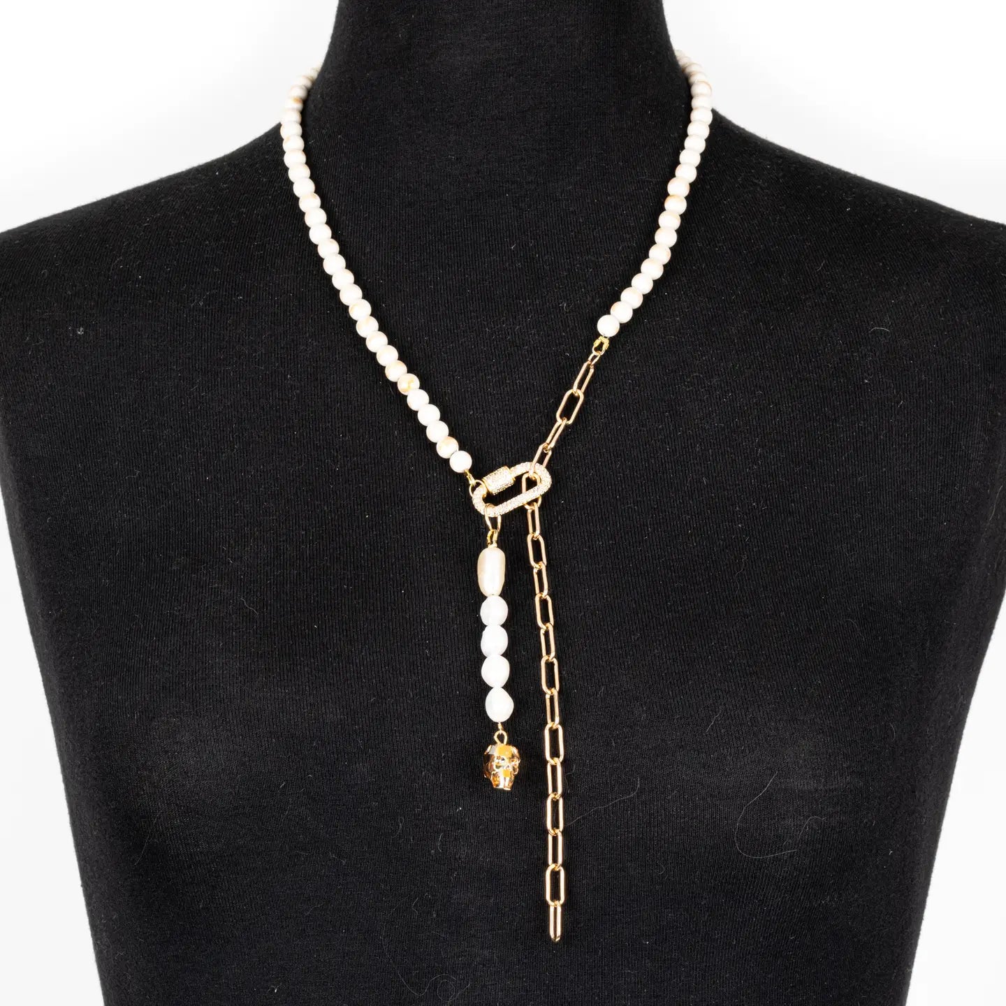 Pearl necklace with gold chain drop detail and crystal accent on white background.