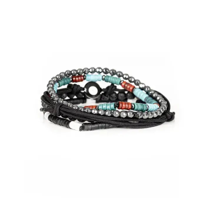 Men’s layered bracelet set featuring matte black lava stone beads, faceted hematite crystal beads, turquoise heishi beads, coral-red accent beads, black braided cord wraps, white and black spacer beads, and an evil eye centerpiece, stacked in a bold bohemian luxury design on a white background.
