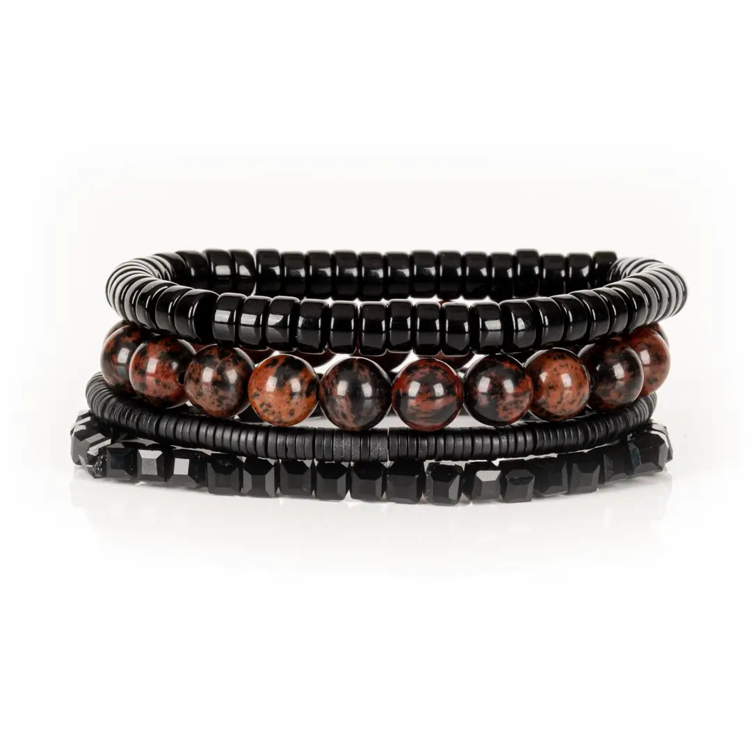 Men’s layered bracelet set featuring black lava stone disc beads, black braided cord wraps, white and gray marbled natural stone beads, black hematite coil beads, and light gray heishi beads, stacked in a sophisticated monochromatic luxury design on a white background.