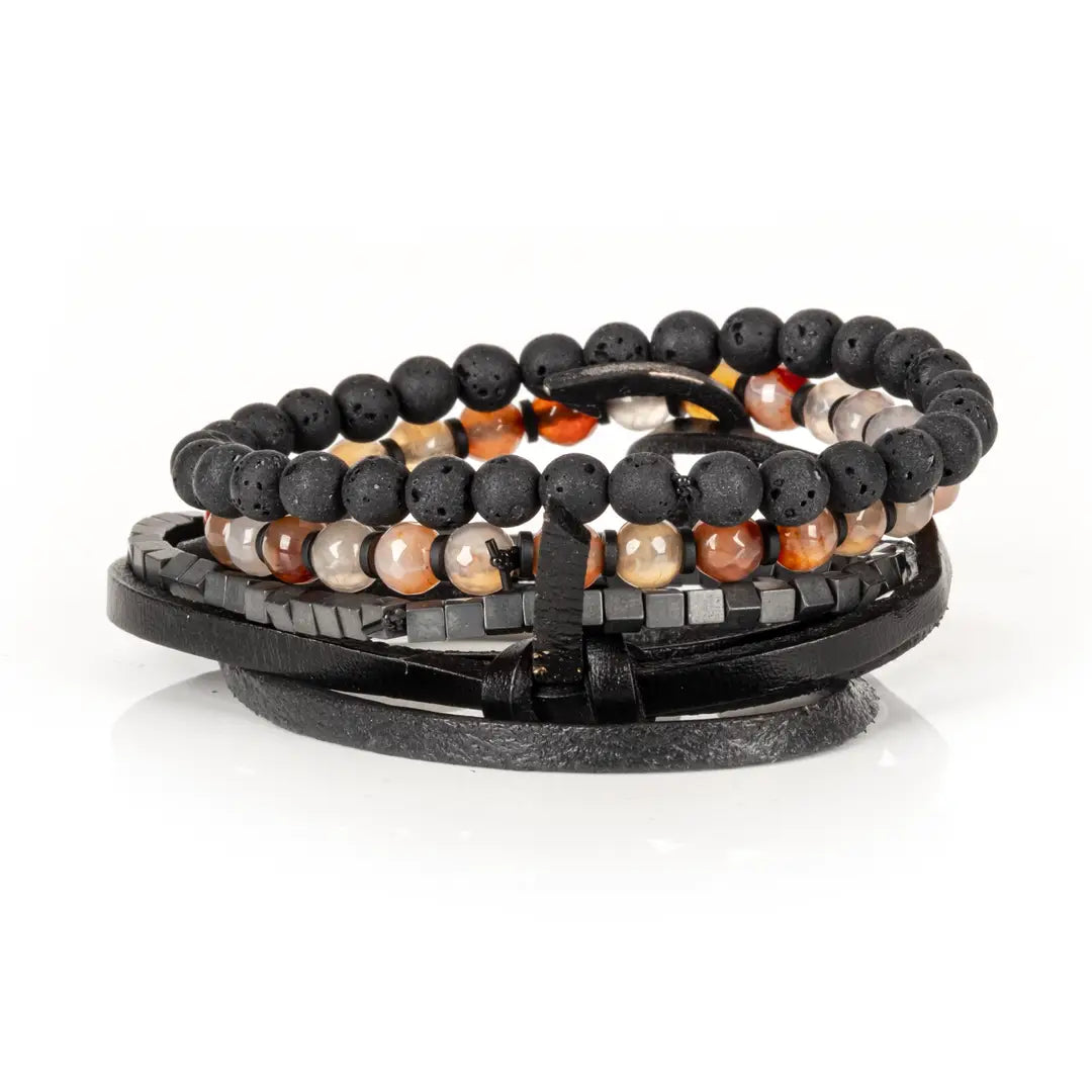 Men's layered bracelet set featuring matte black lava stone beads, faceted brown and cream agate gemstone beads, dark hematite cube beads, and black leather wrap straps arranged in a handcrafted stacked design on a white background.