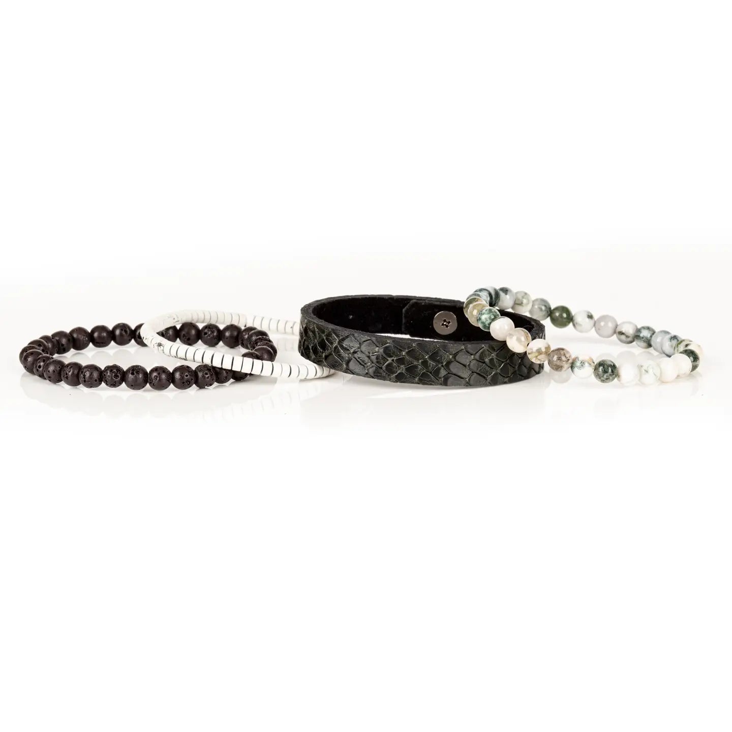 Men’s layered bracelet set featuring a black embossed leather cuff with a reptile-inspired texture, white howlite beads, green moss agate stone beads, white heishi beads, and dark lava stone beads, stacked in a sophisticated natural luxury design on a white background.