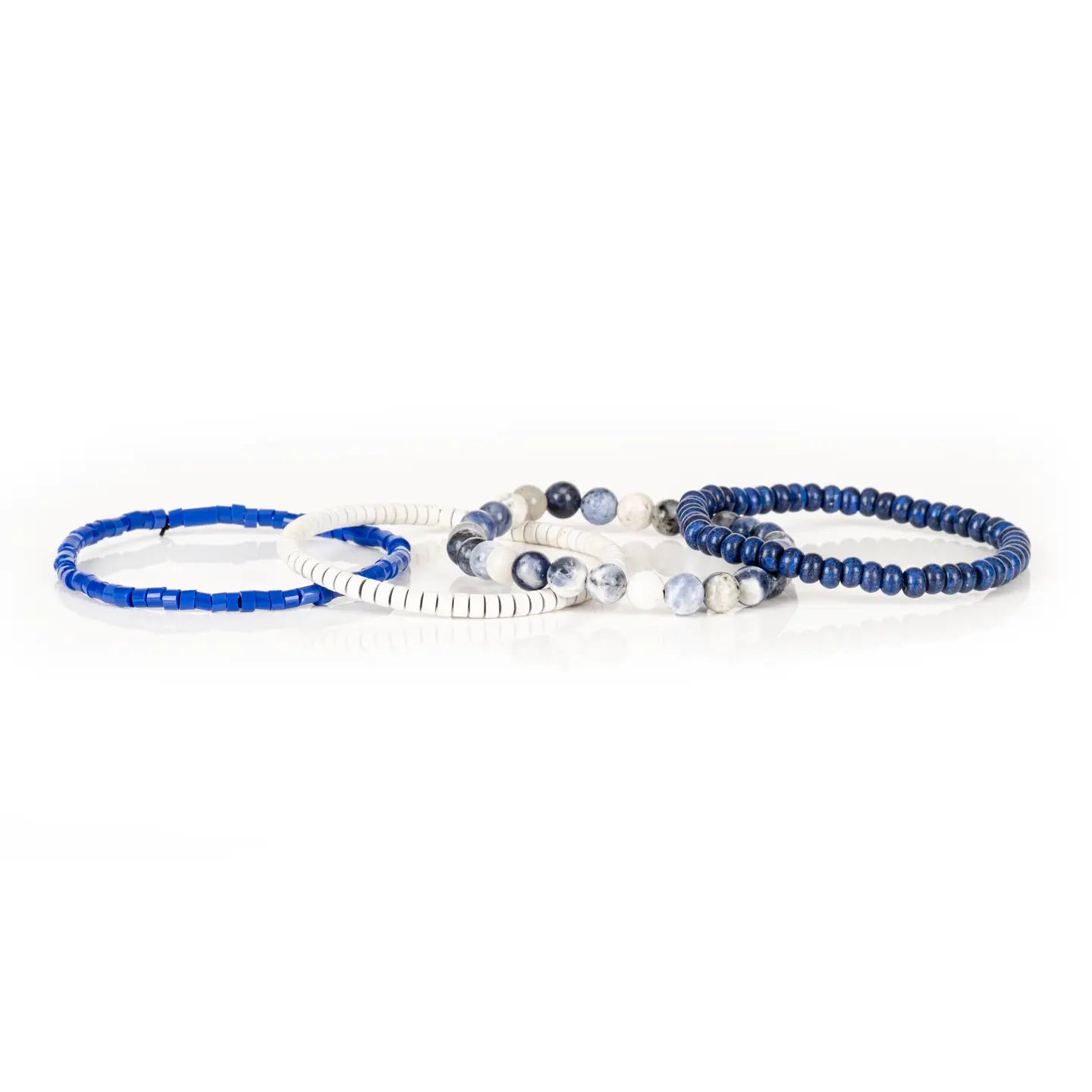 Men’s layered bracelet set featuring deep blue lapis-style heishi beads, blue and white marbled natural stone beads, white howlite heishi beads, and bright blue accent beads, stacked in a sophisticated nautical-inspired luxury design on a white background.