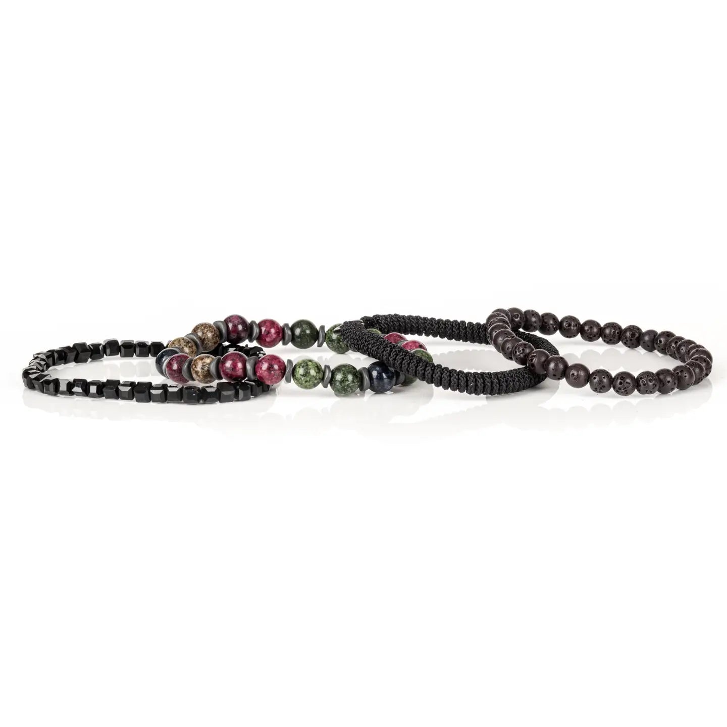 Men's layered bracelet set featuring faceted black crystal cube beads, multicolor natural gemstone beads in green, burgundy, navy, and beige tones, black woven cord detailing, and matte black lava stone beads arranged in a stacked design on a white background.