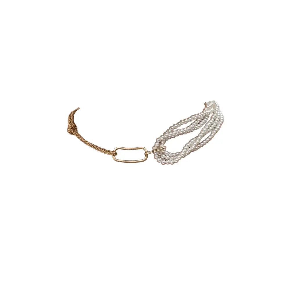 Multi-strand pearl bracelet with a gold link clasp on a white background.