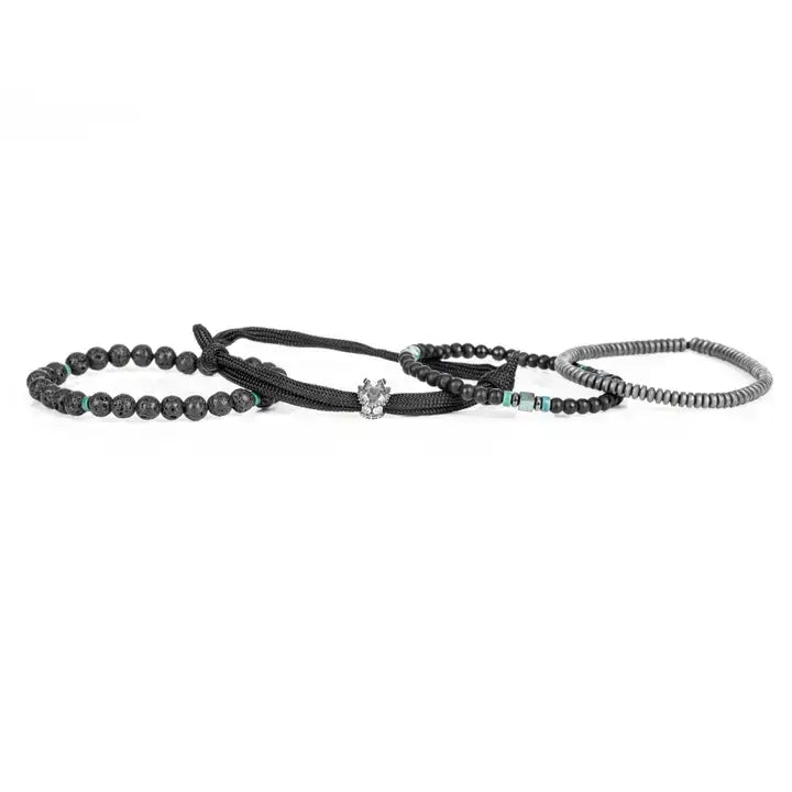Black layered men’s bracelet set with lava stone beads, braided rope wraps, hematite accents, and turquoise detail on white background.