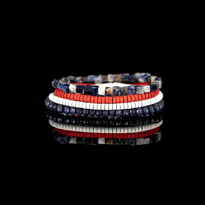 Blue, red, and white multi-layer men’s bracelet set featuring faceted blue beads, natural stone cube beads, and layered colorful disc bead strands on a light background.